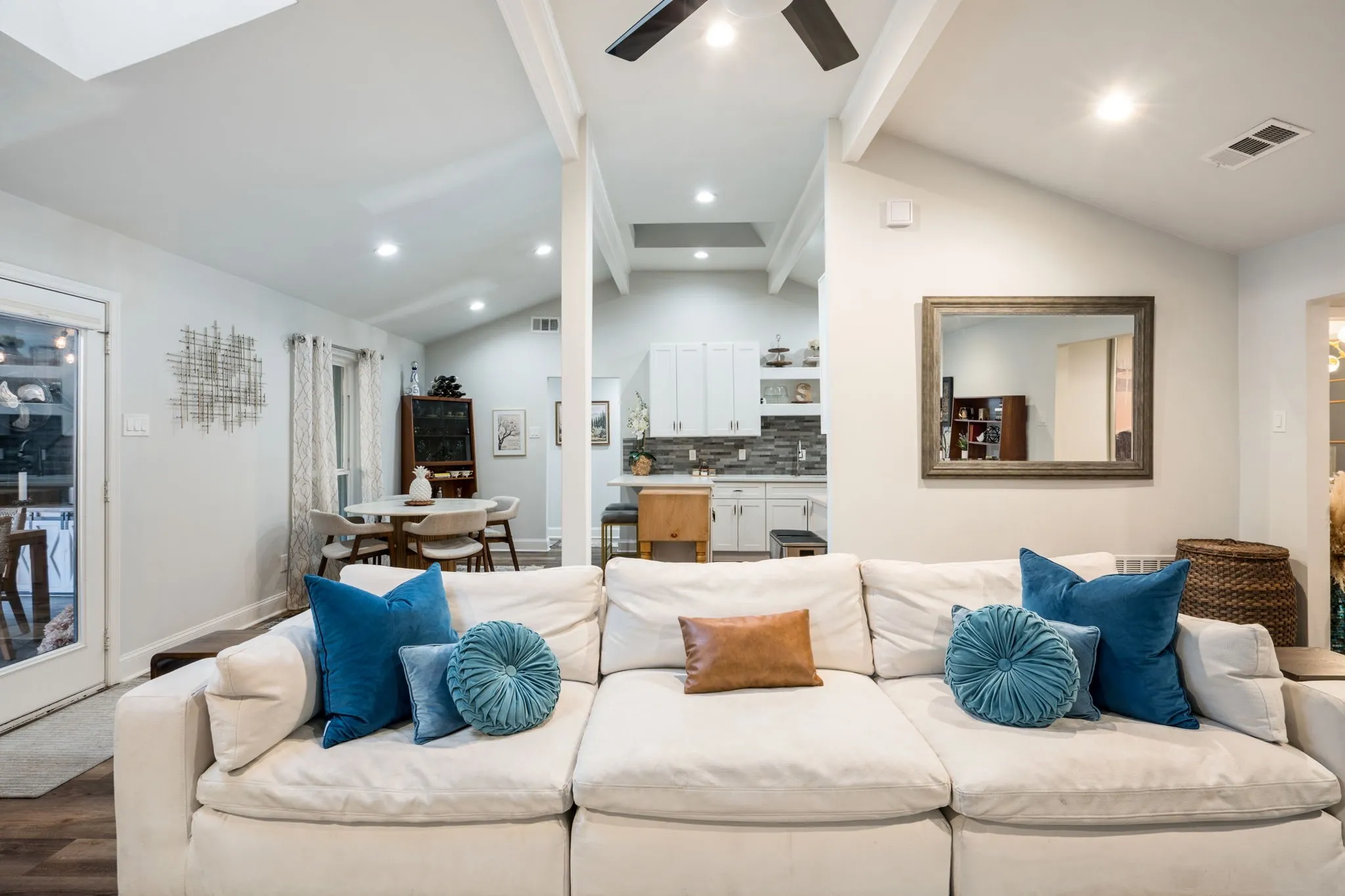 Vaulted ceilings, recessed lighting, and wood-finish flooring