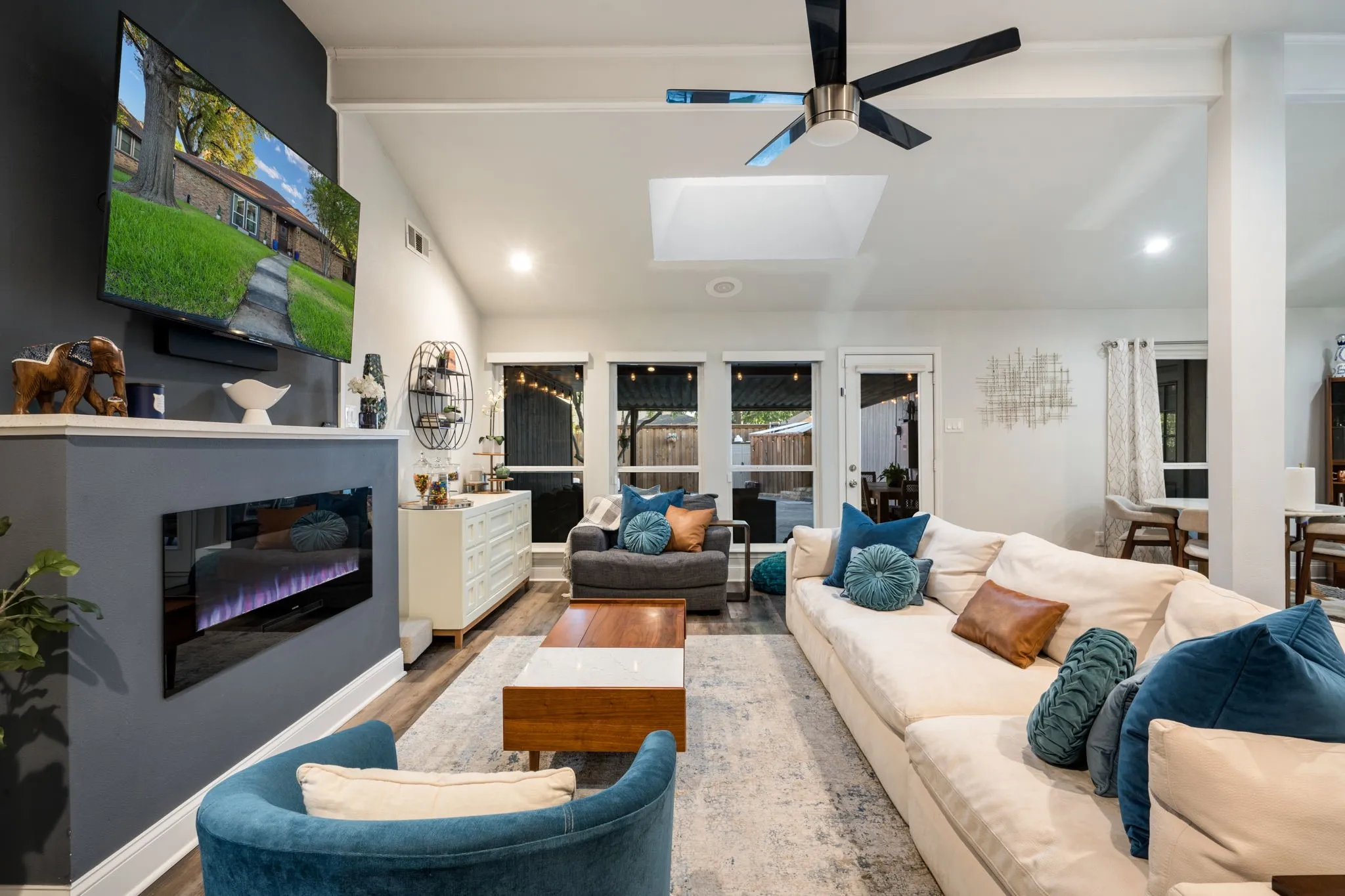 Vaulted ceiling with a skylight and contemporary ceiling fan