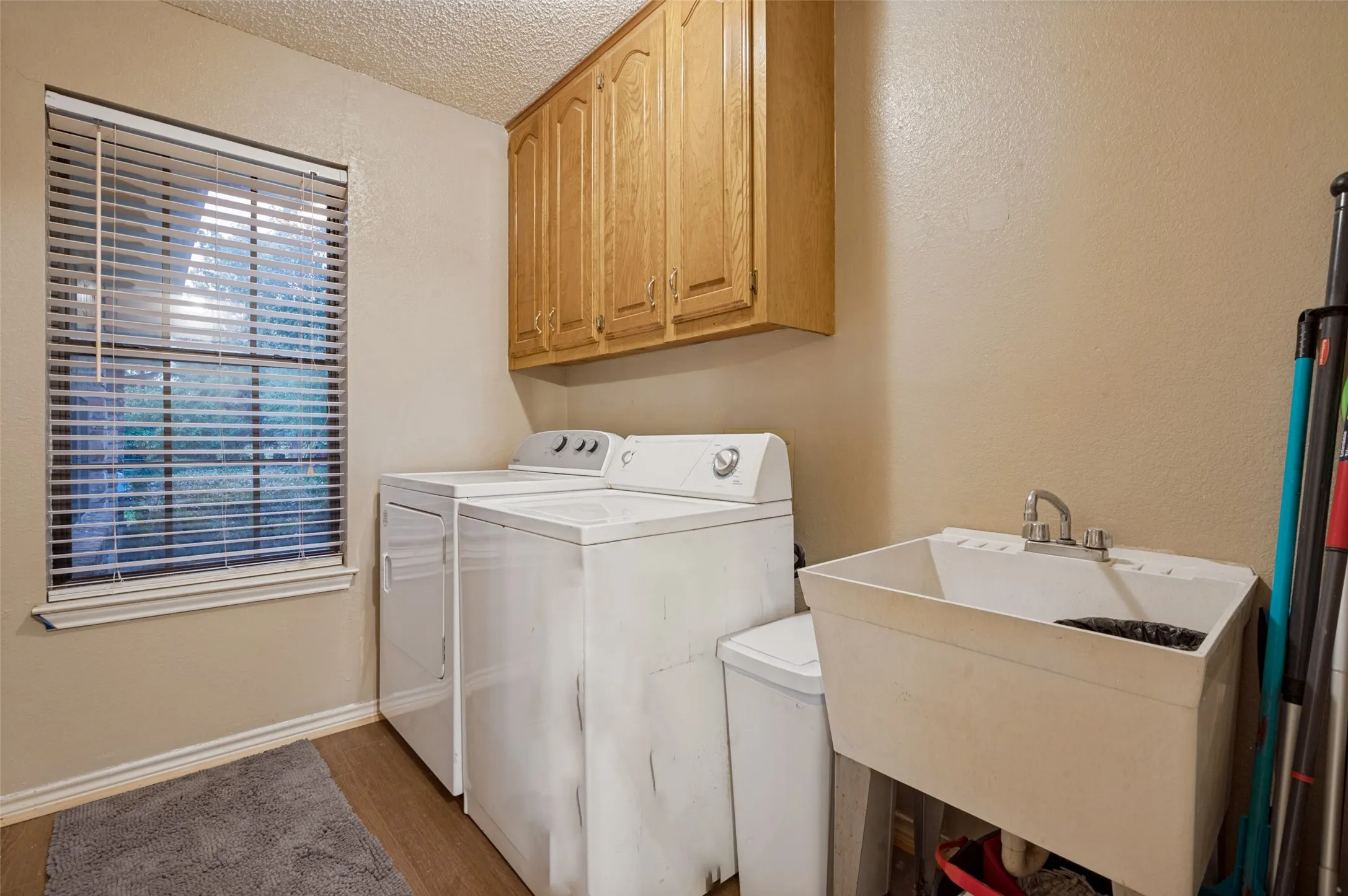 dedicated laundry room with sink and window overlooking the backyar