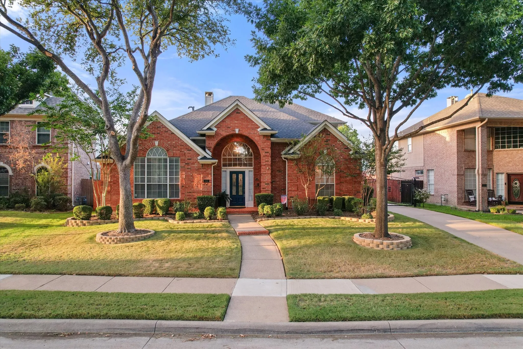 Brick exterior with an arched entryway and transom window