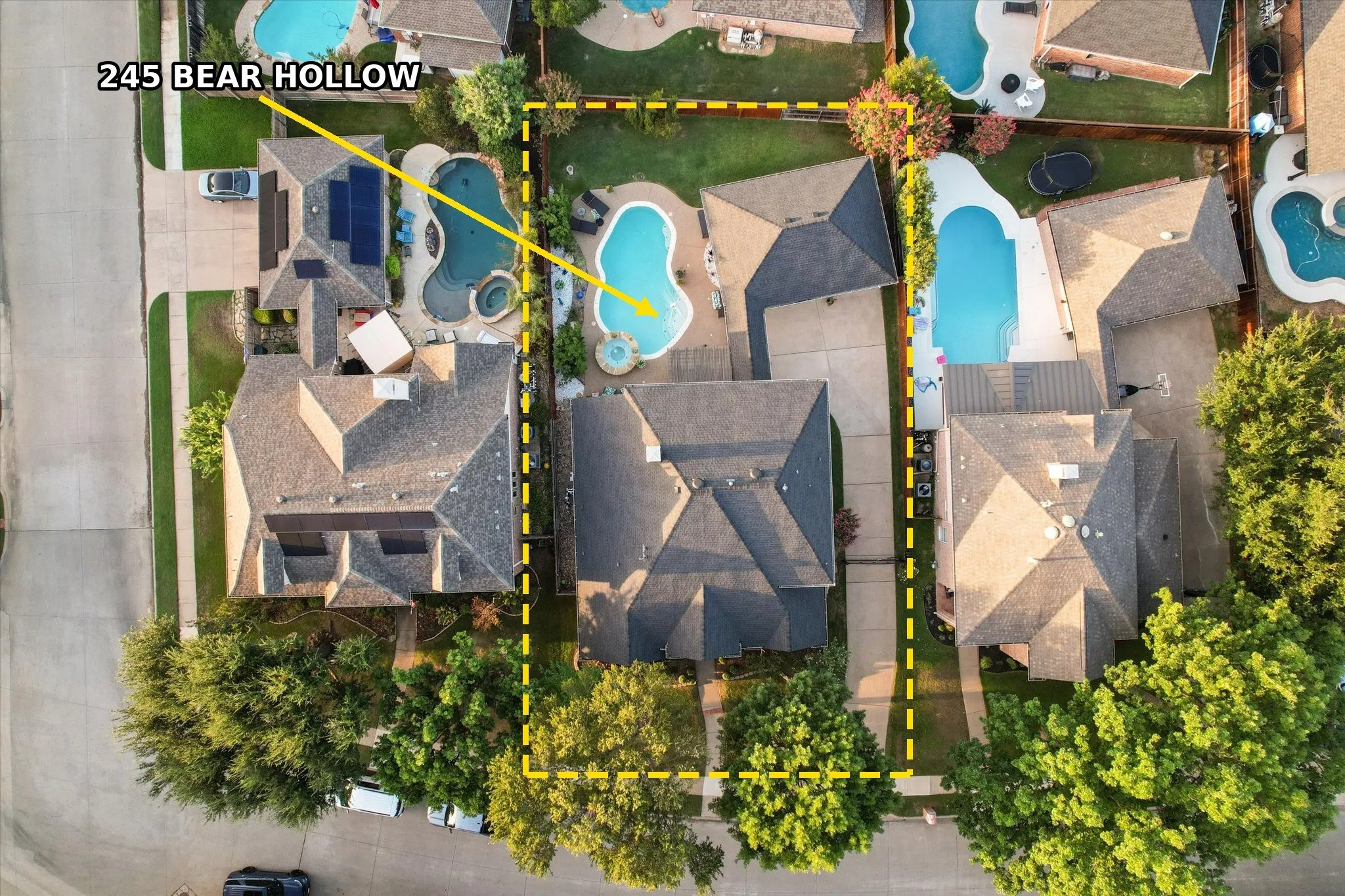 Gable rooflines with asphalt shingles, mature trees. Lines are approx.