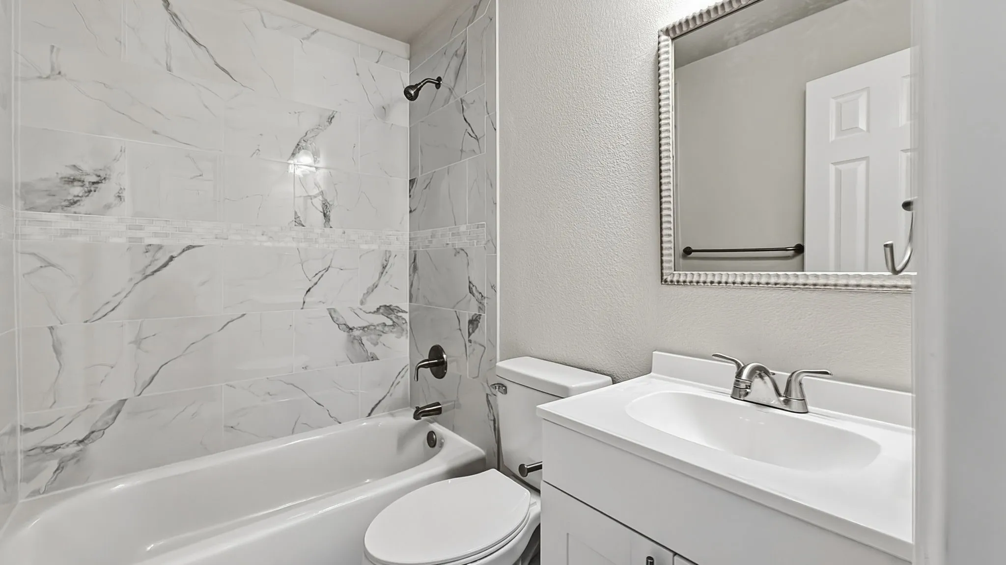 White vanity with an integrated sink and chrome faucet
