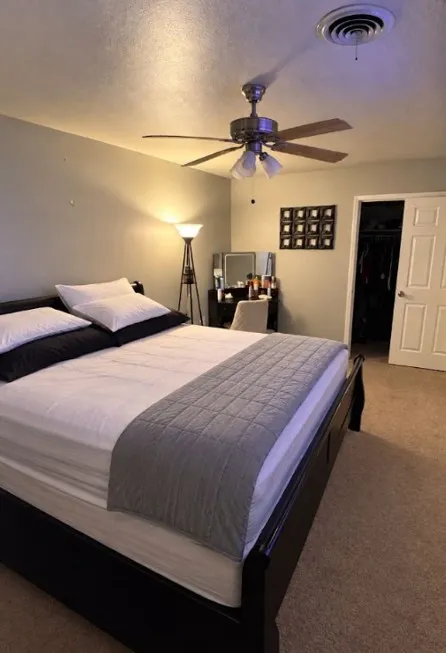 Nice and spacious bedroom with nice ceiling fans.