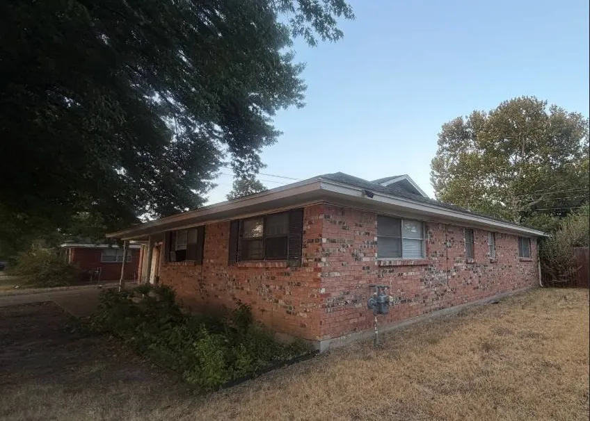 Side view of home with great mature trees.