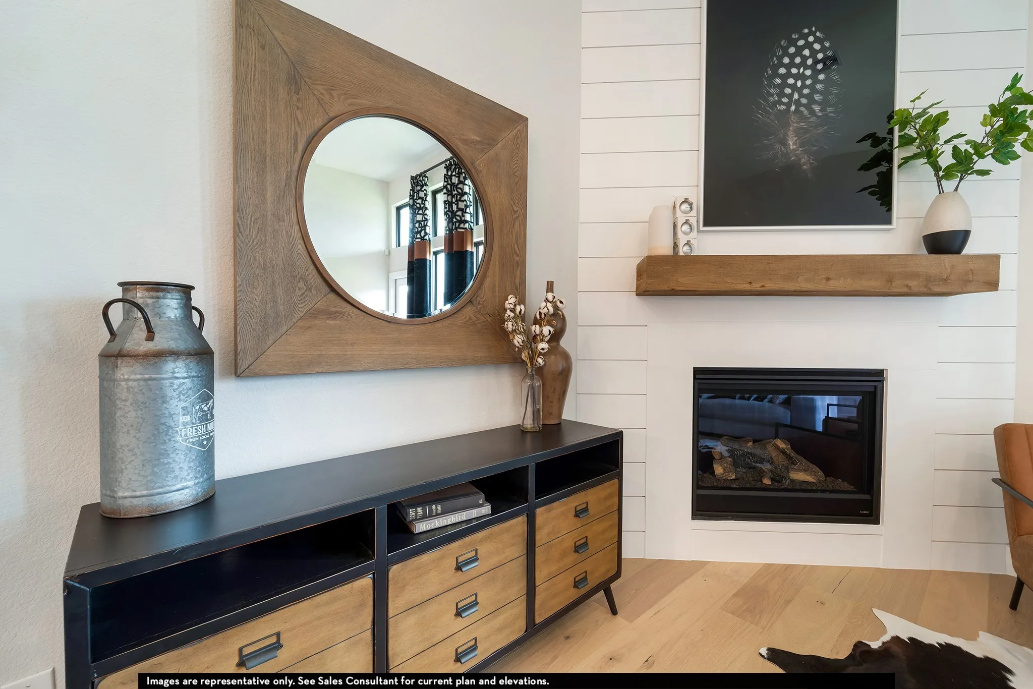 Shiplap fireplace surround with a wood mantel, embedded fireplace, and light wood-finish flooring