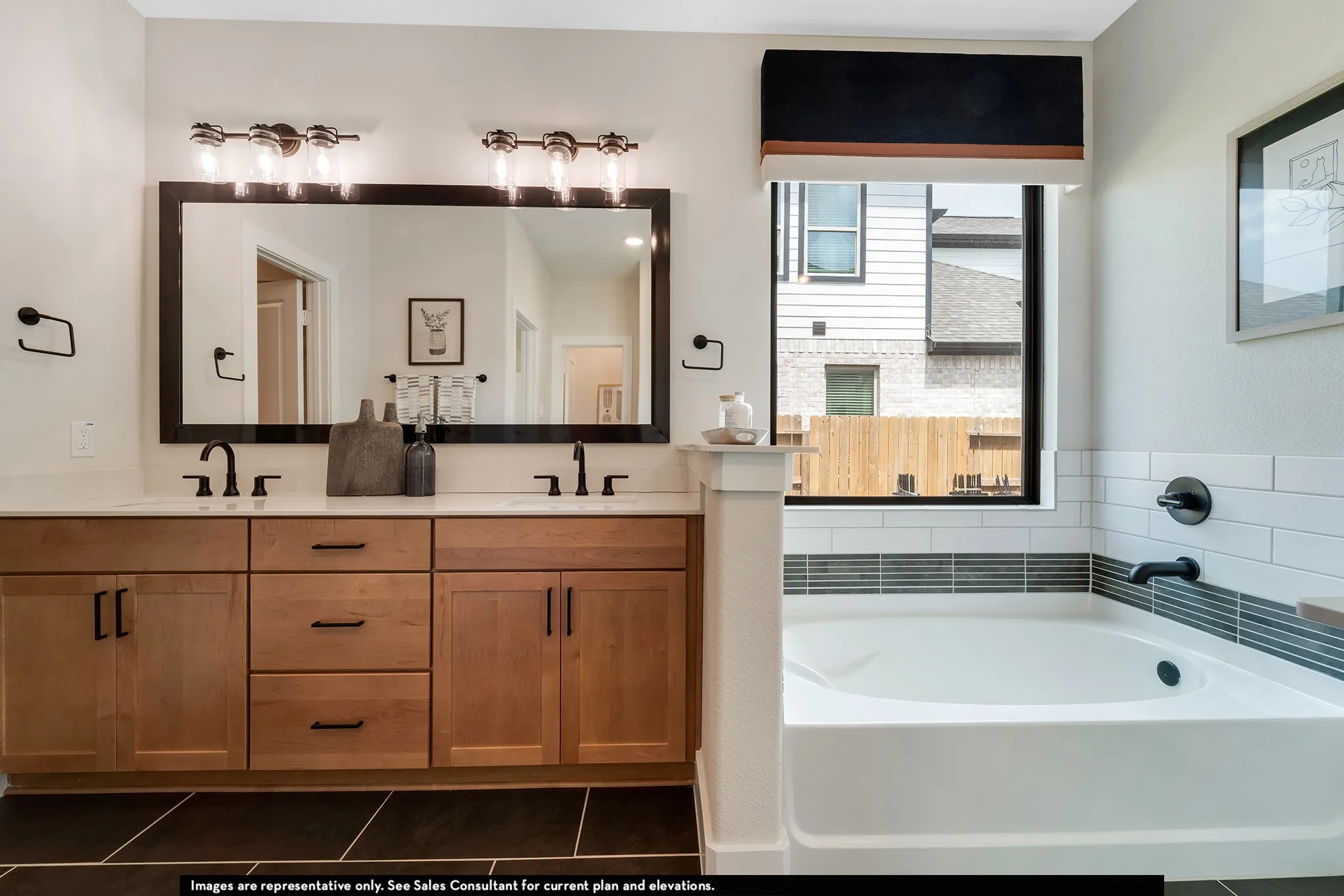 Dual sink vanity with wood-finish cabinetry, white countertops, and black hardware
