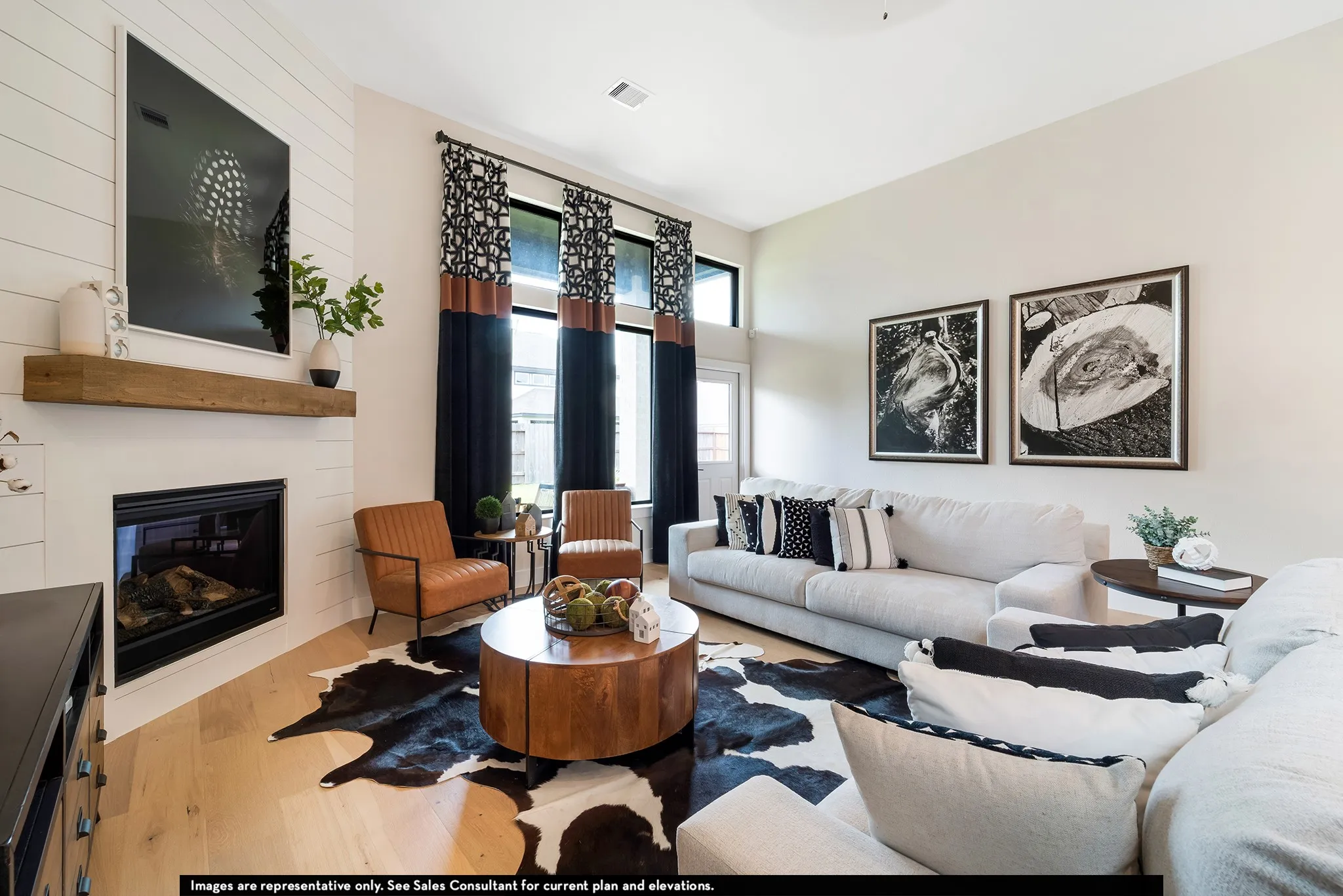 Shiplap accent wall with a built-in fireplace, wood mantel, and light wood-finish flooring