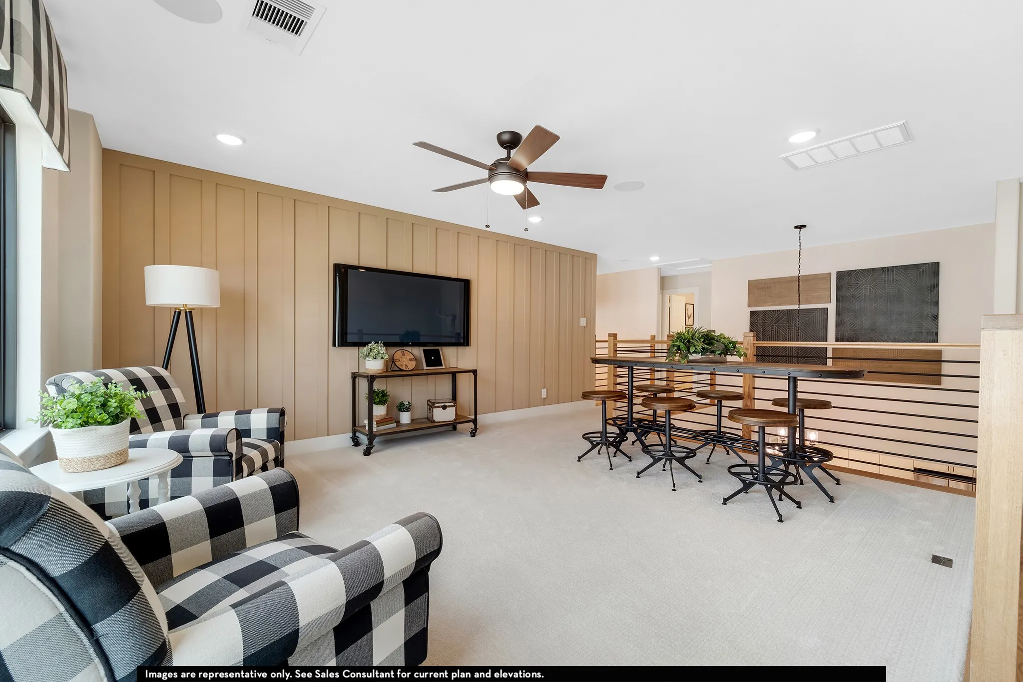 Recessed lighting, ceiling fan, natural light from window, horizontal railing, and light-toned wall paneling