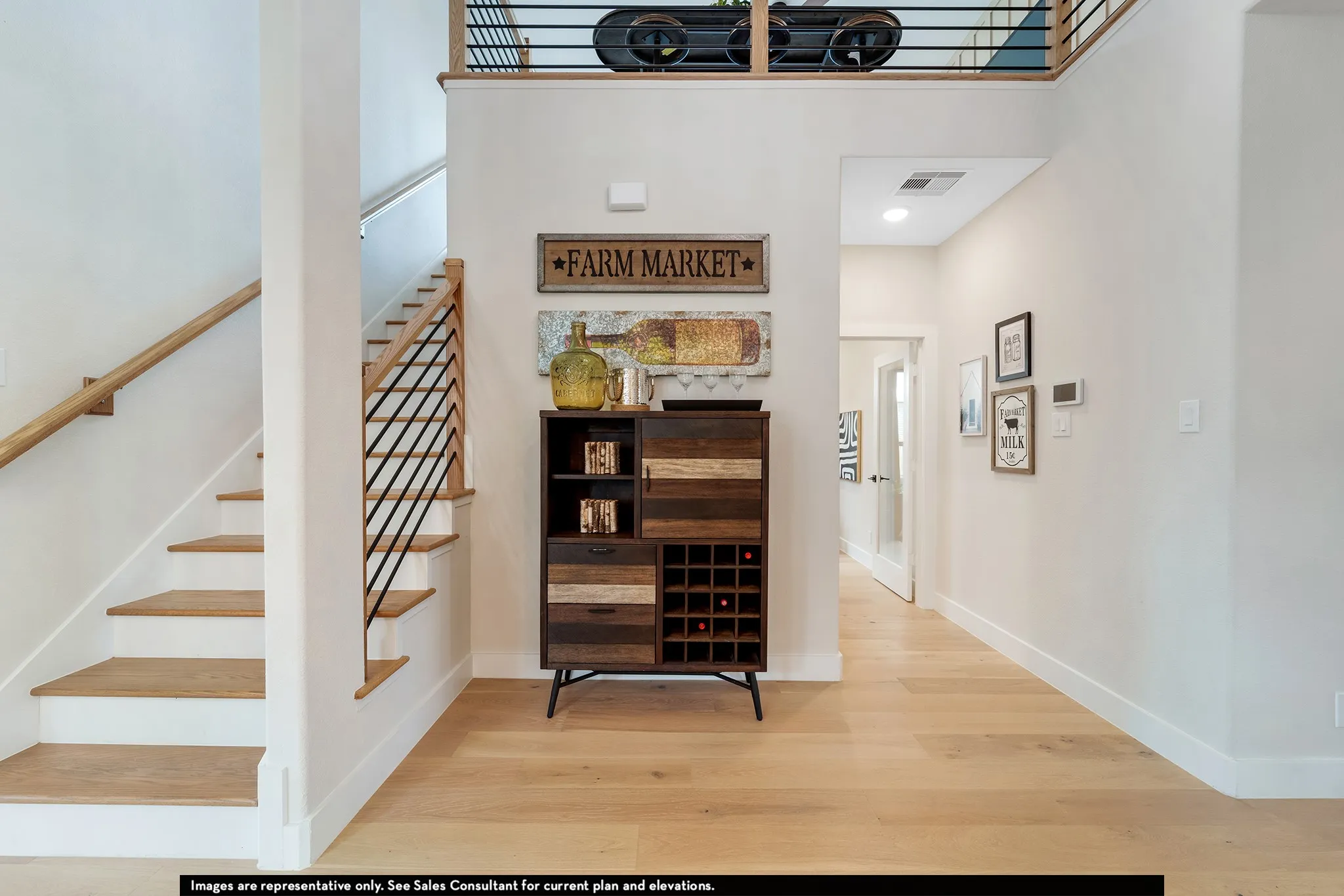 Hardwood-finish flooring, staircase with natural wood handrail, open-tread staircase, light-toned wall finishes, recessed lighting