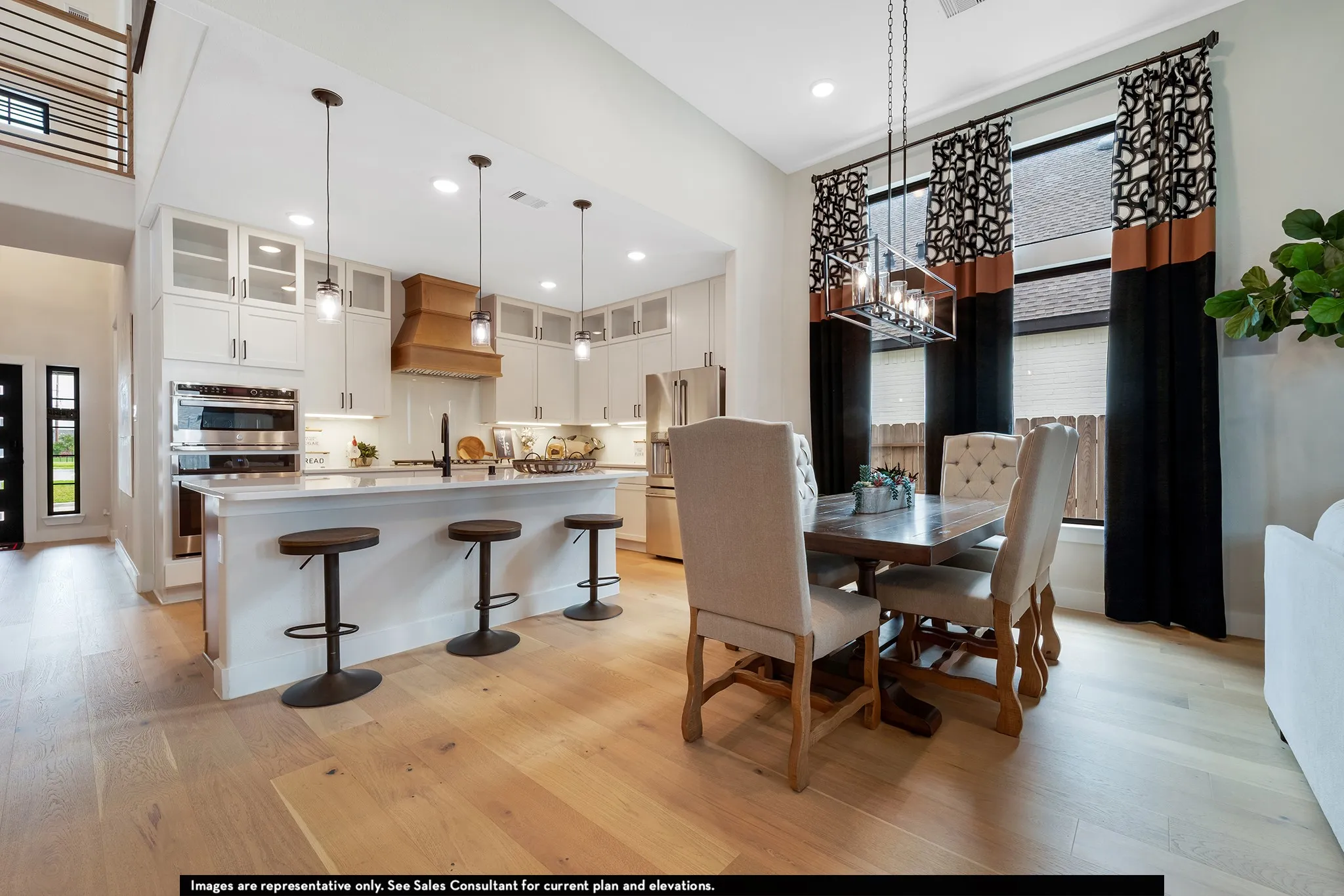 Gourmet kitchen with stainless steel appliances, central island, and wood-finish flooring