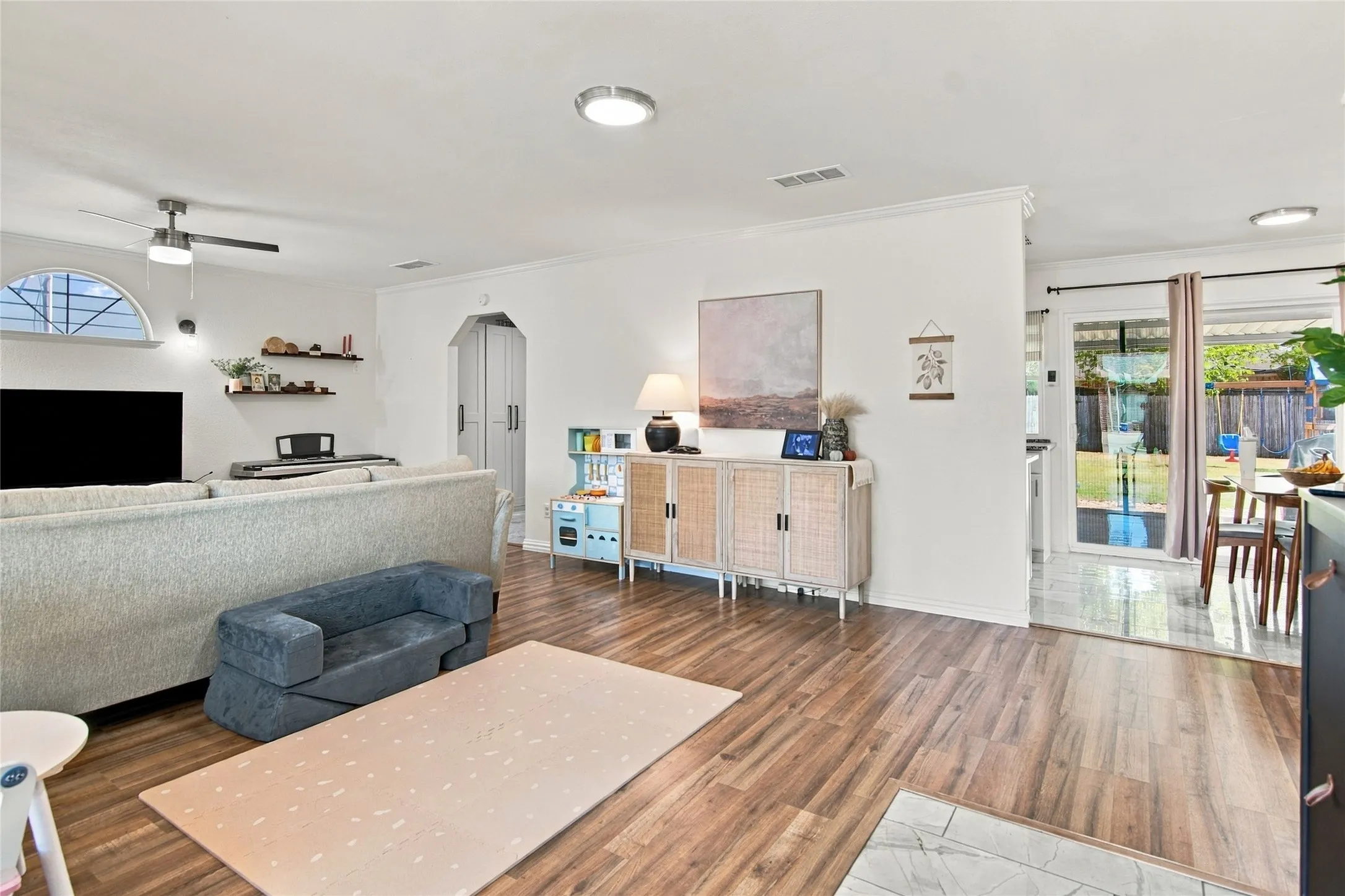 Wood-finish flooring throughout, recessed lighting, and a ceiling fan