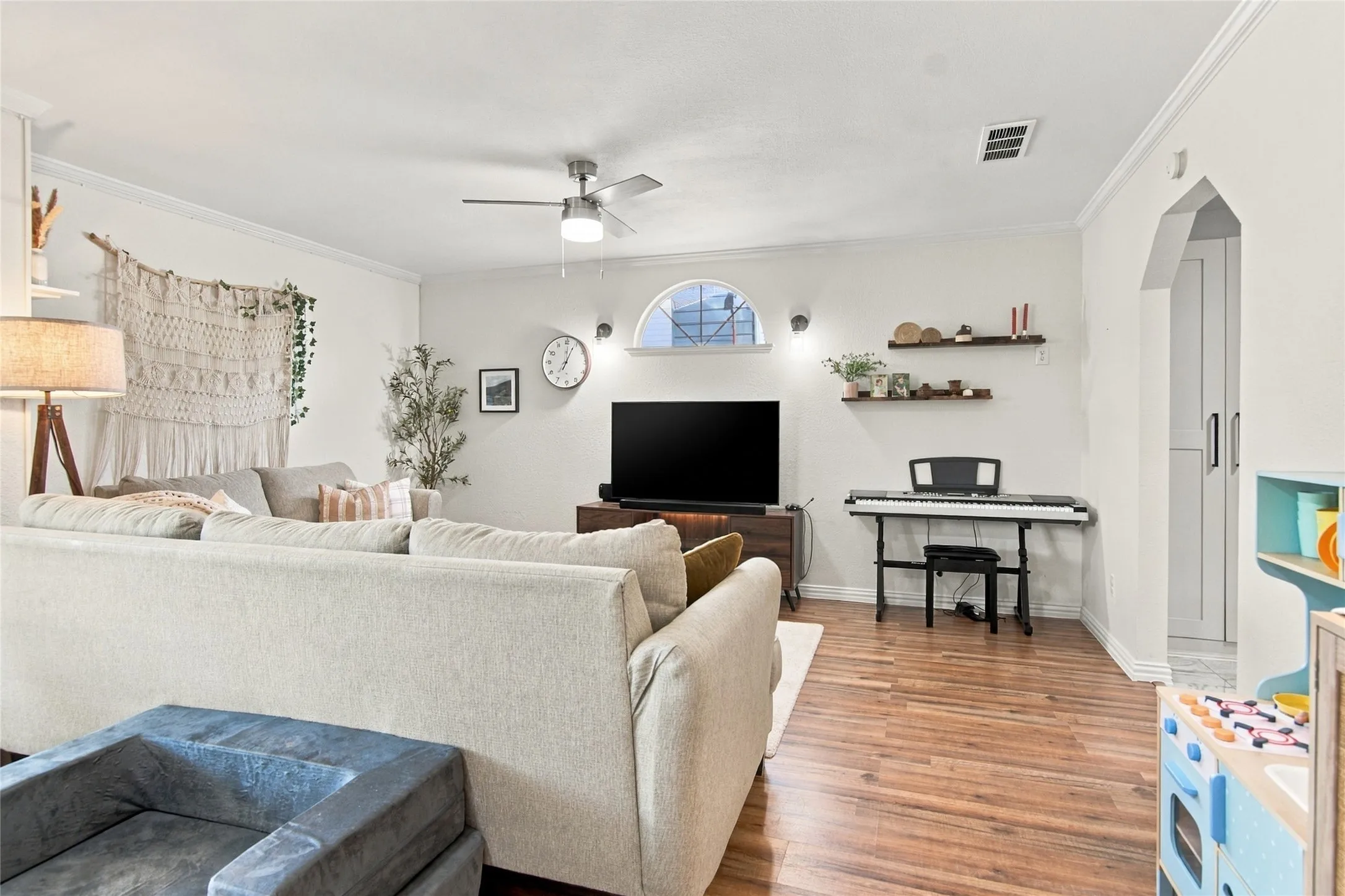 Wood-finish flooring throughout, complemented by a ceiling fan with integrated lighting