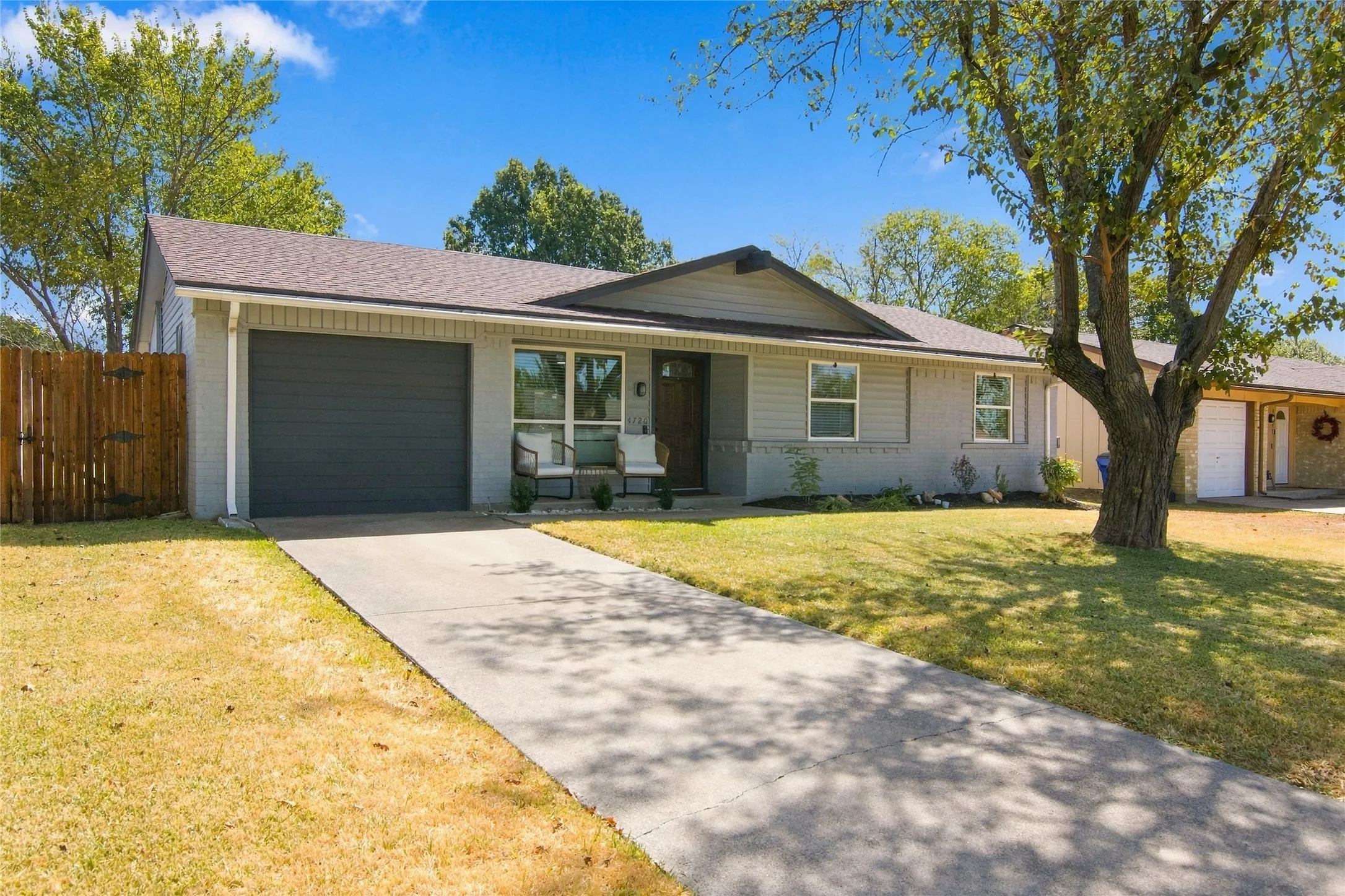 Single-story residence featuring a two-car garage, concrete driveway, and a front porch