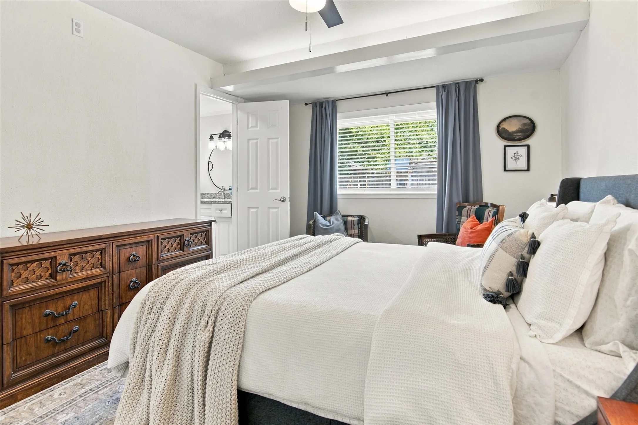 Vaulted ceiling with exposed beams and ceiling fan