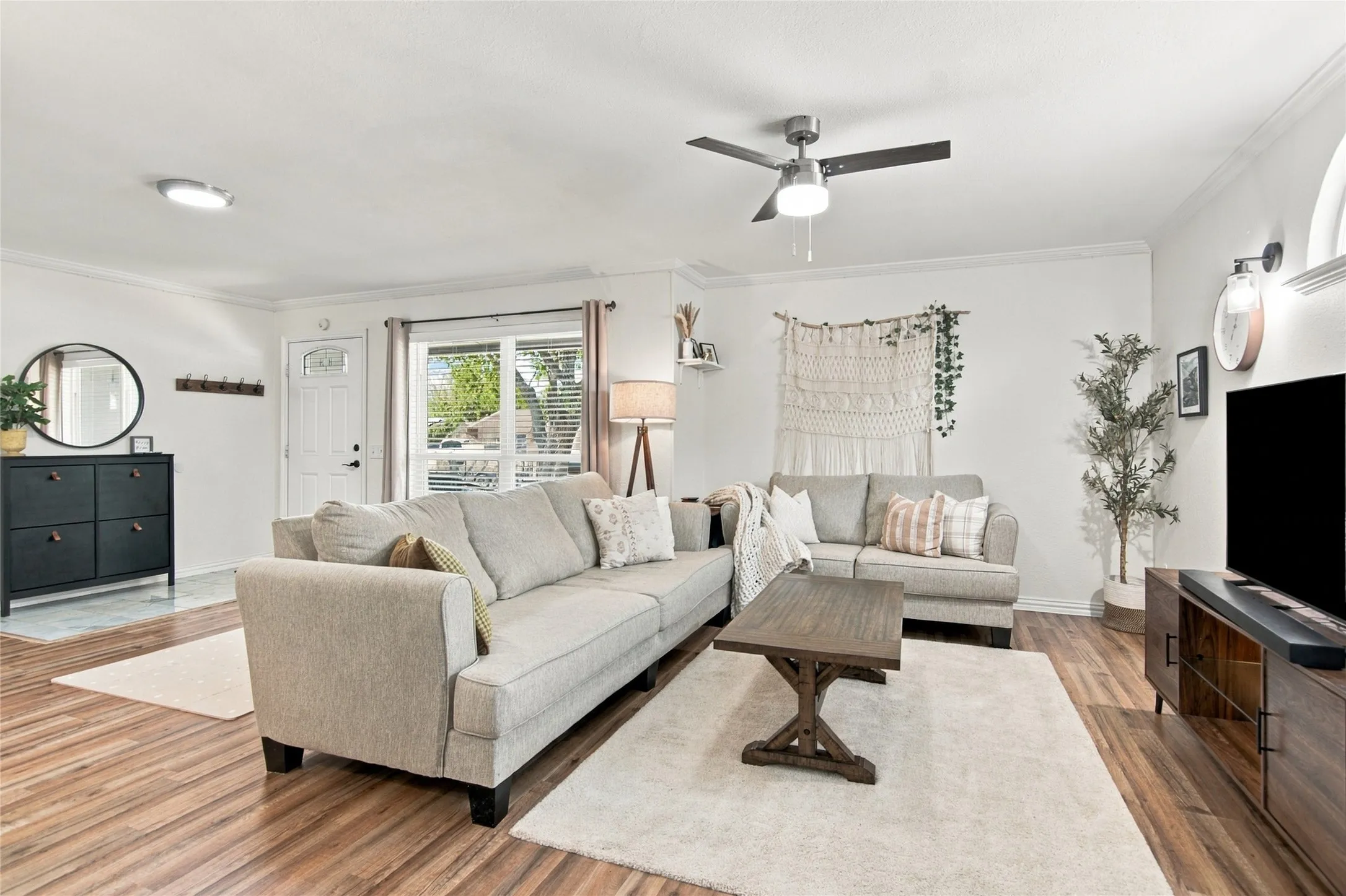 Wood-finish flooring throughout, complemented by a ceiling fan with integrated lighting