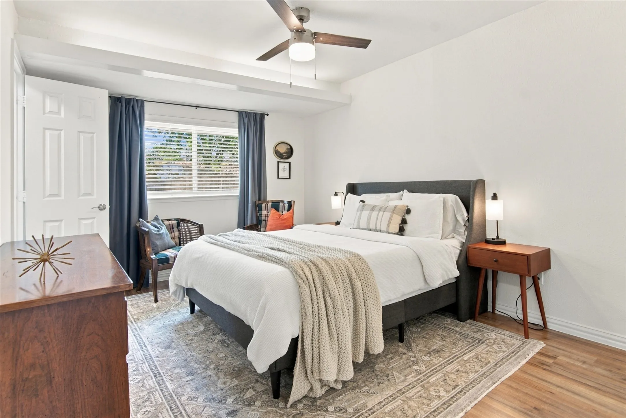 Wood-finish flooring with a ceiling fan, recessed lighting, and white paneled door