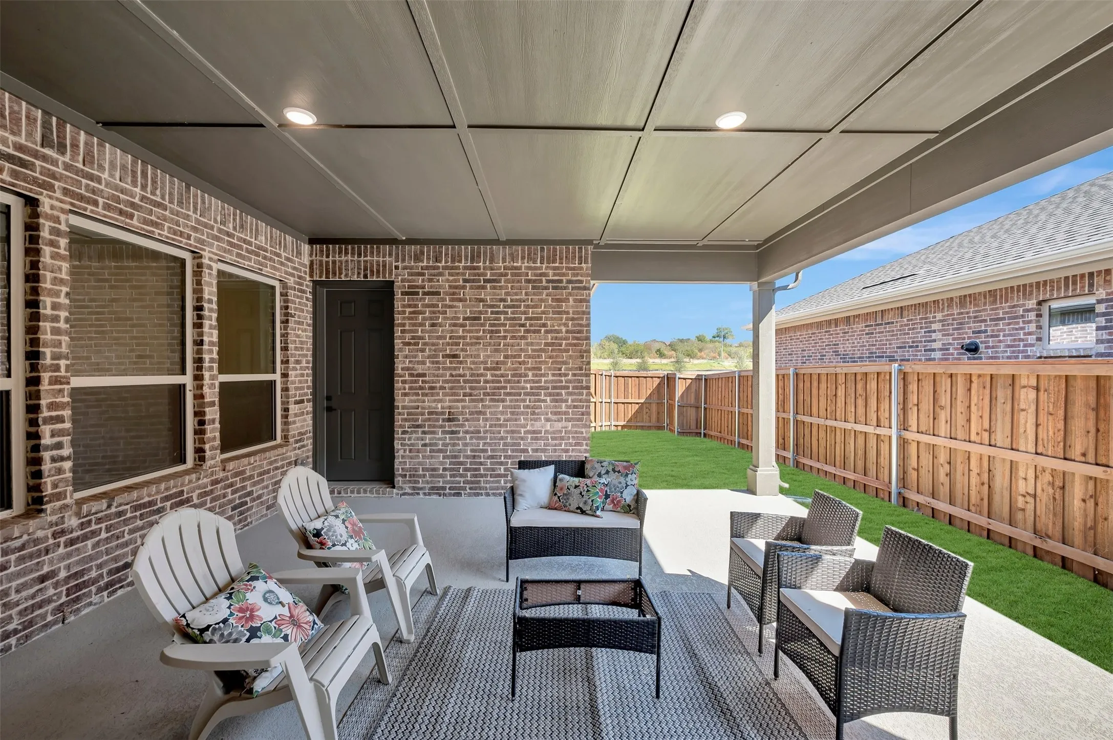 Covered patio with recessed lighting, concrete flooring, and a full brick exterior