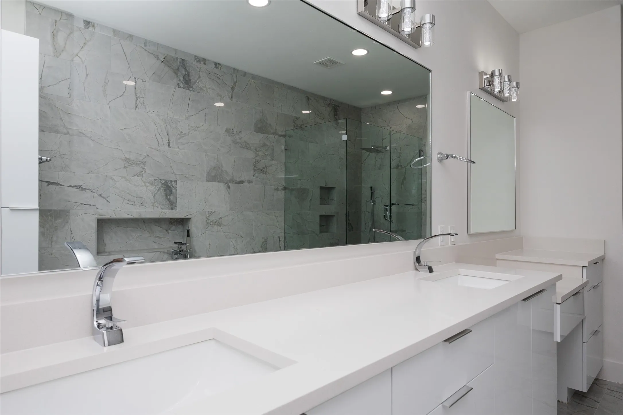 Dual vanity with integrated sinks, chrome fixtures, and a spacious countertop
