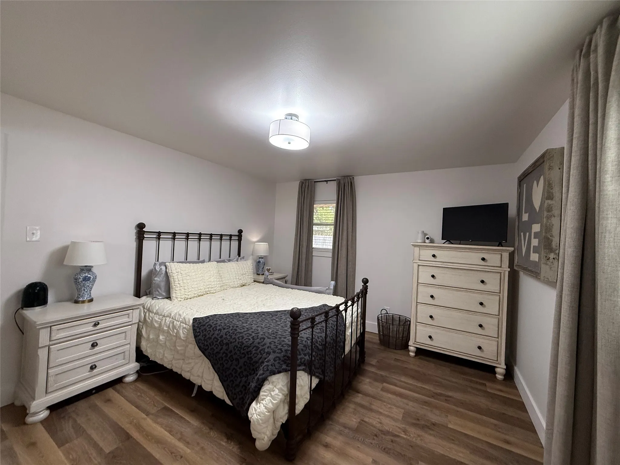Luxury Plank Flooring, white walls, and a contemporary ceiling light fixture
