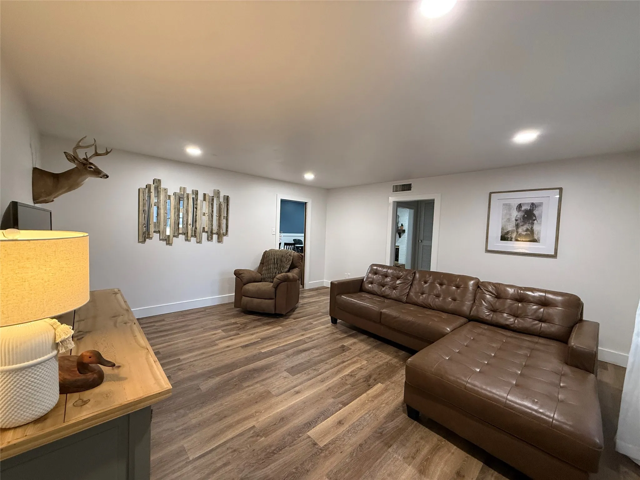 Recessed ceiling lighting, wood-Luxury plank flooring, white wall paint, and white trim