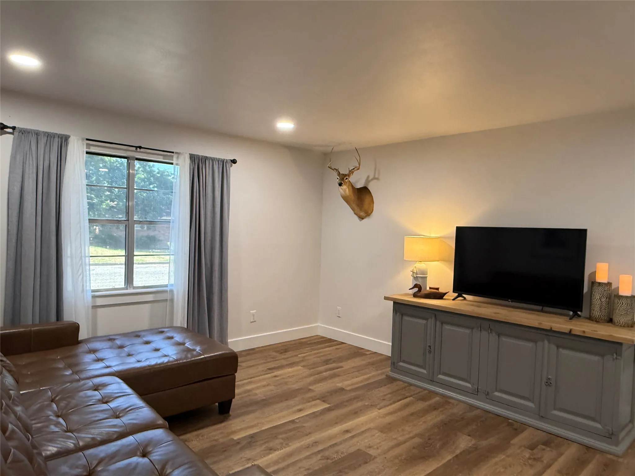 Recessed ceiling lighting, Luxury flooring, and a multi-pane window