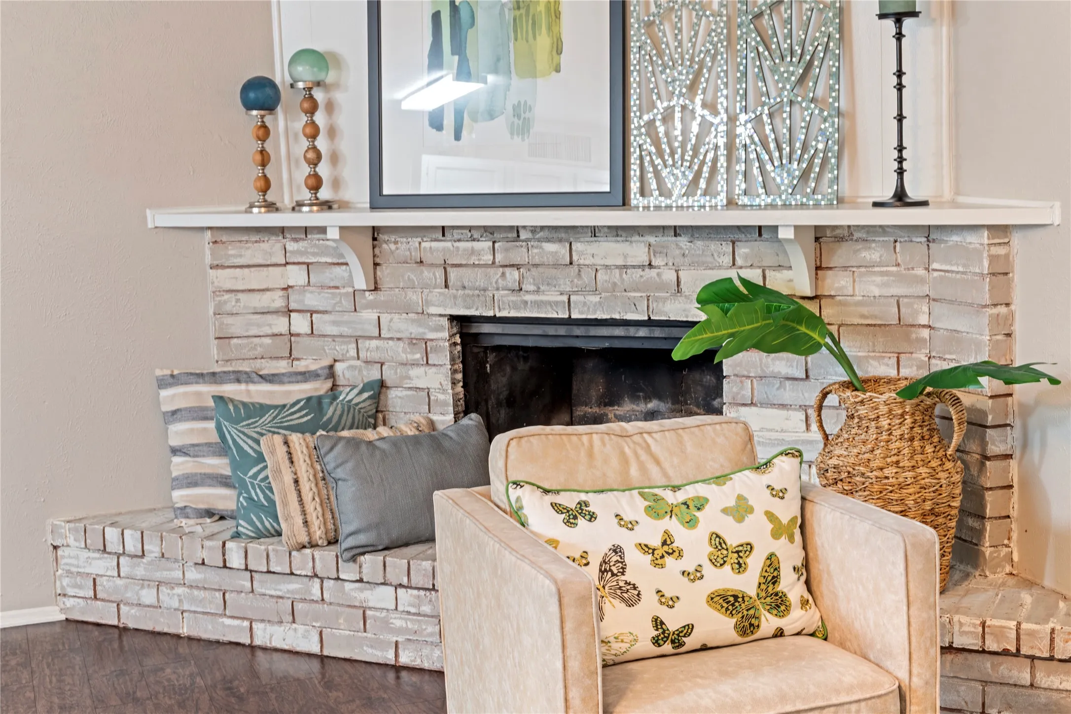 Brick fireplace with a substantial hearth and wood-finish flooring