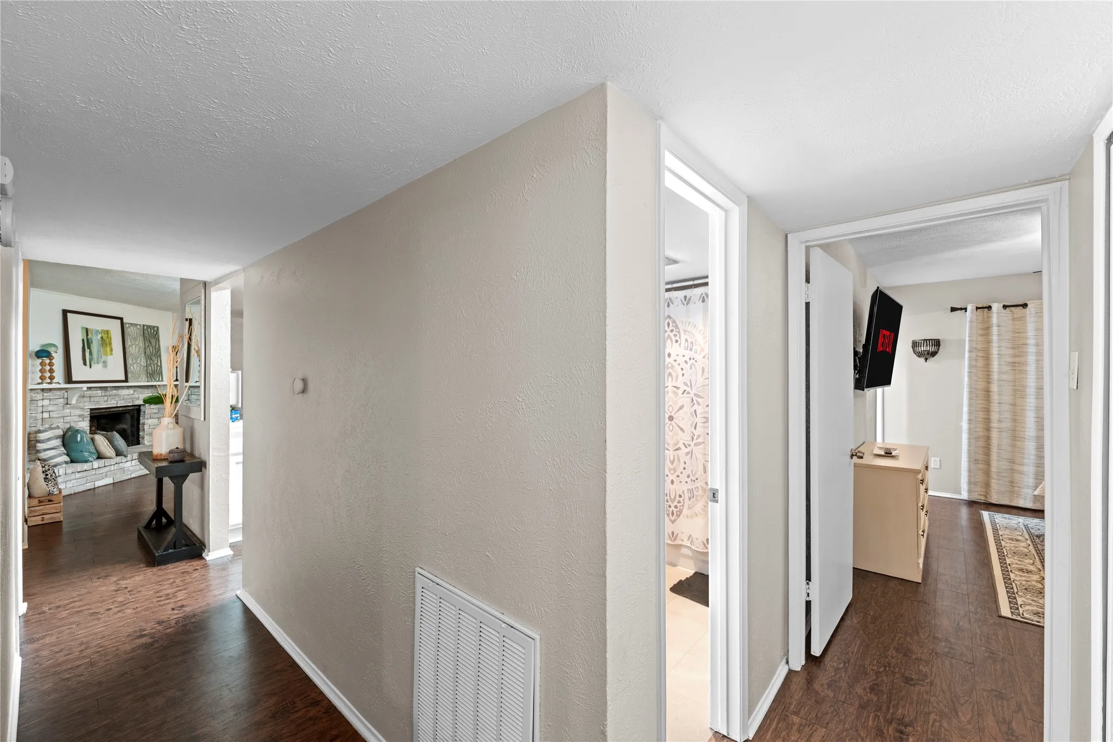 Wood-finish flooring throughout, white trim, and light neutral wall paint
