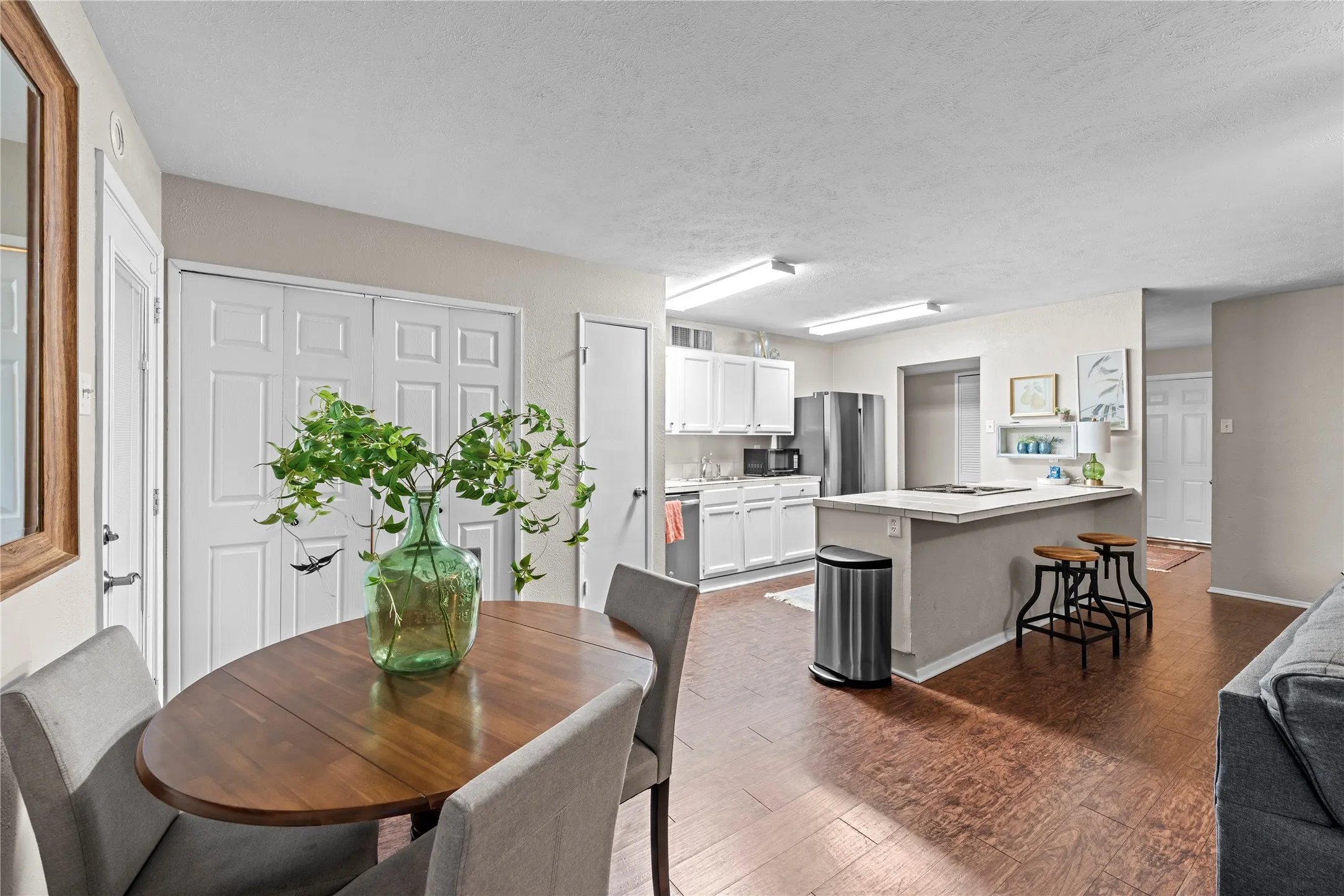 Open-concept living space with wood-finish flooring