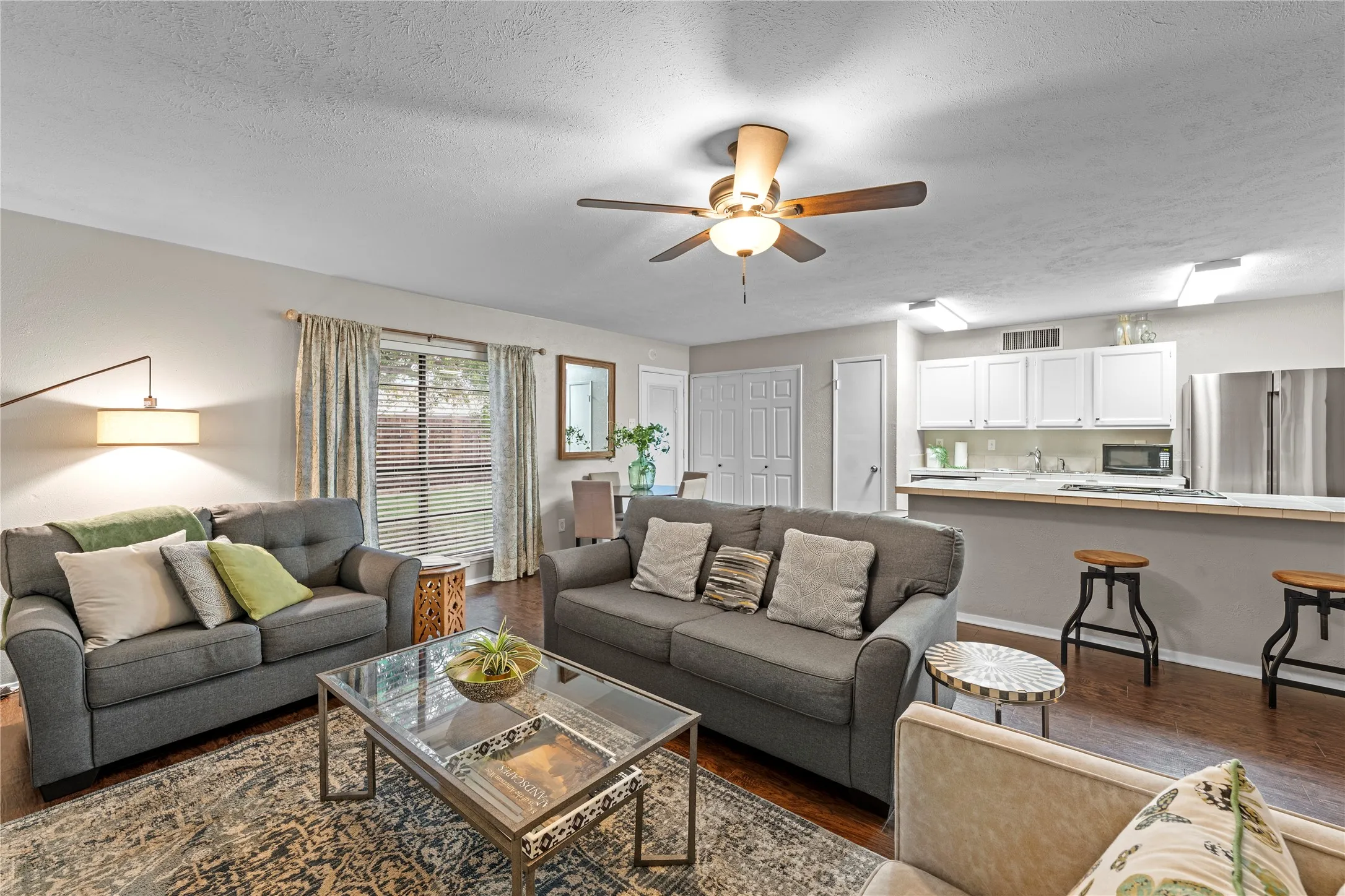 Open-concept living space featuring wood-finish flooring
