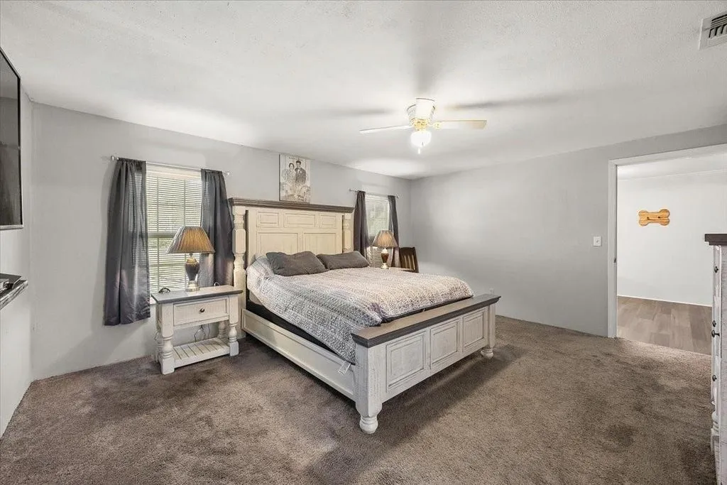 Primary bedroom perspective showcasing room for large furniture pieces and bright natural window light.