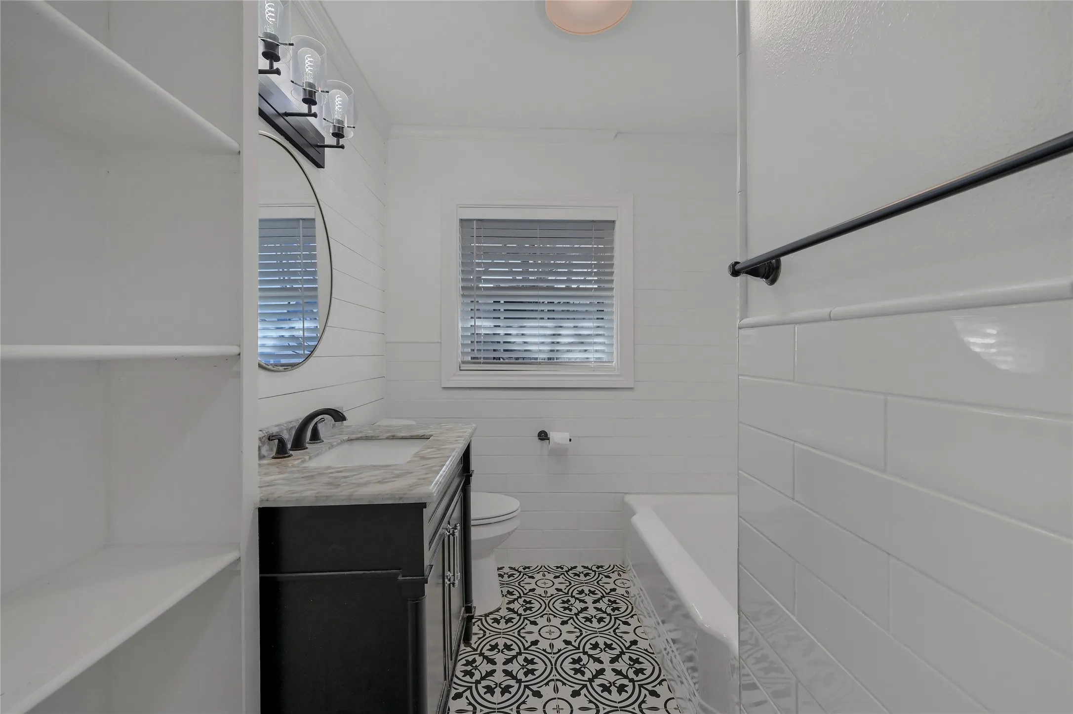 Bathroom with tile patterned floors, vanity, and toilet