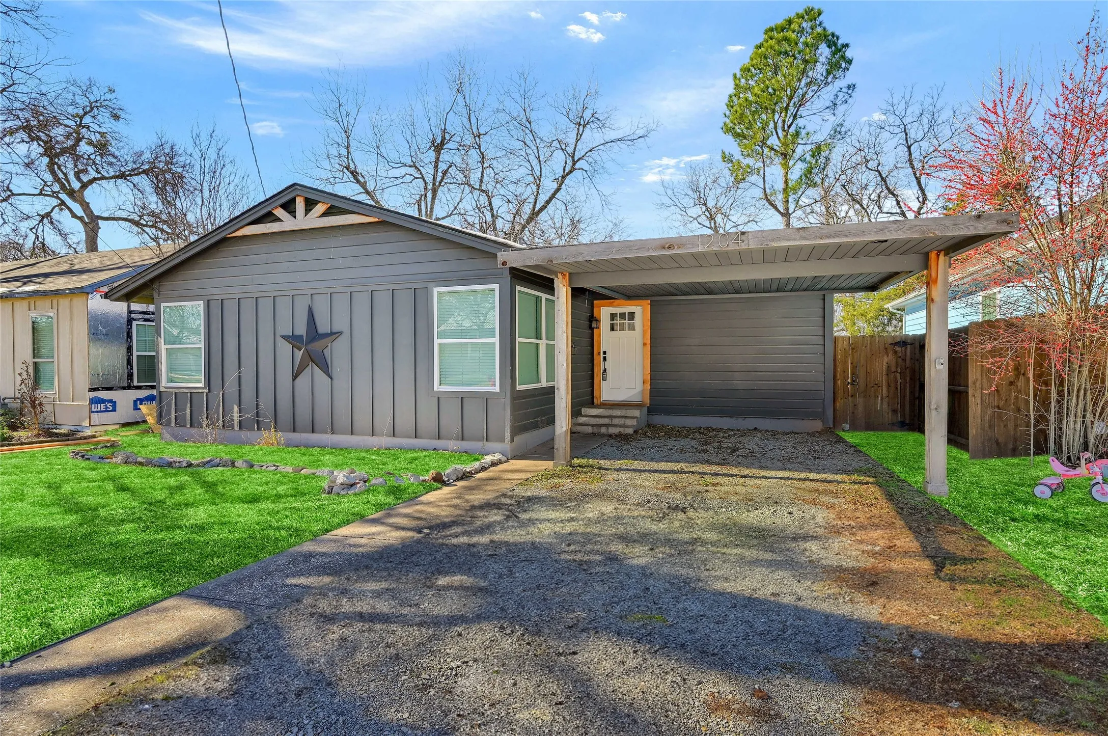 View of front of house with a front lawn and a carport