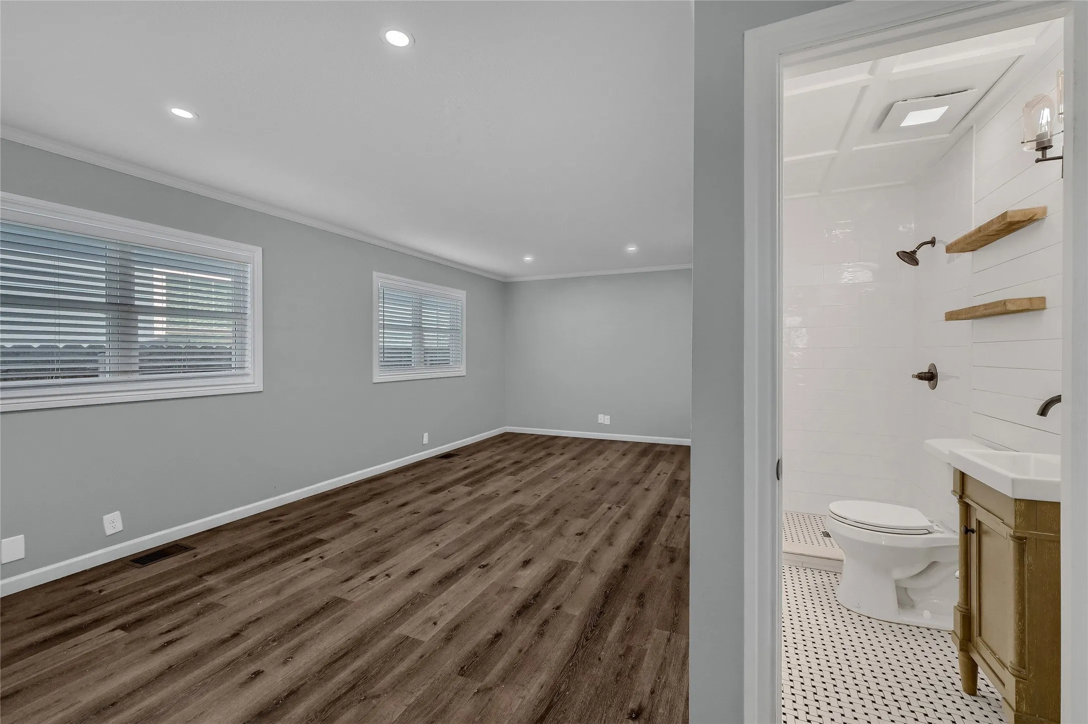 Bathroom with toilet, walk in shower, ornamental molding, and vanity