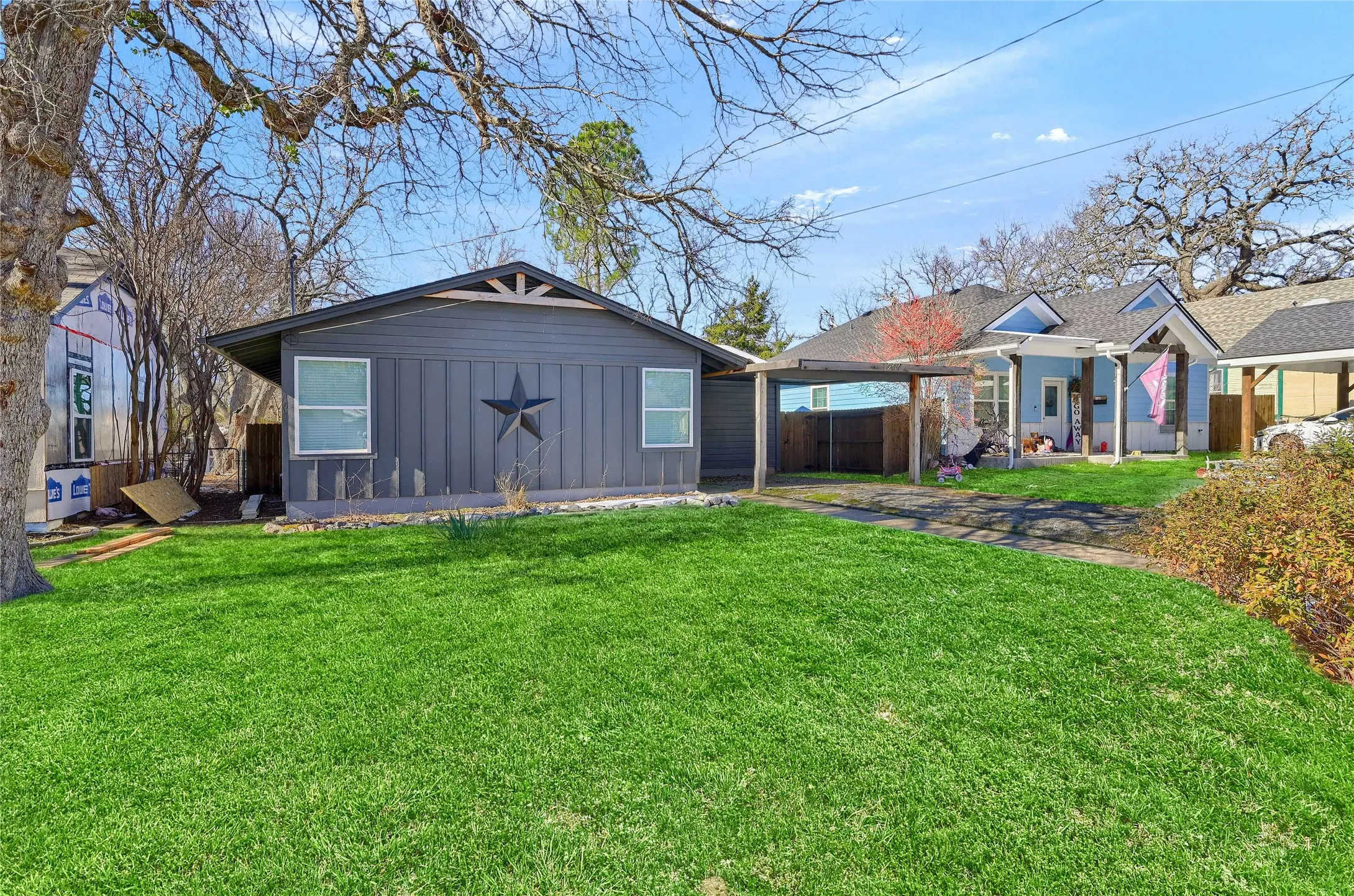 Rear view of house with a yard and a carport