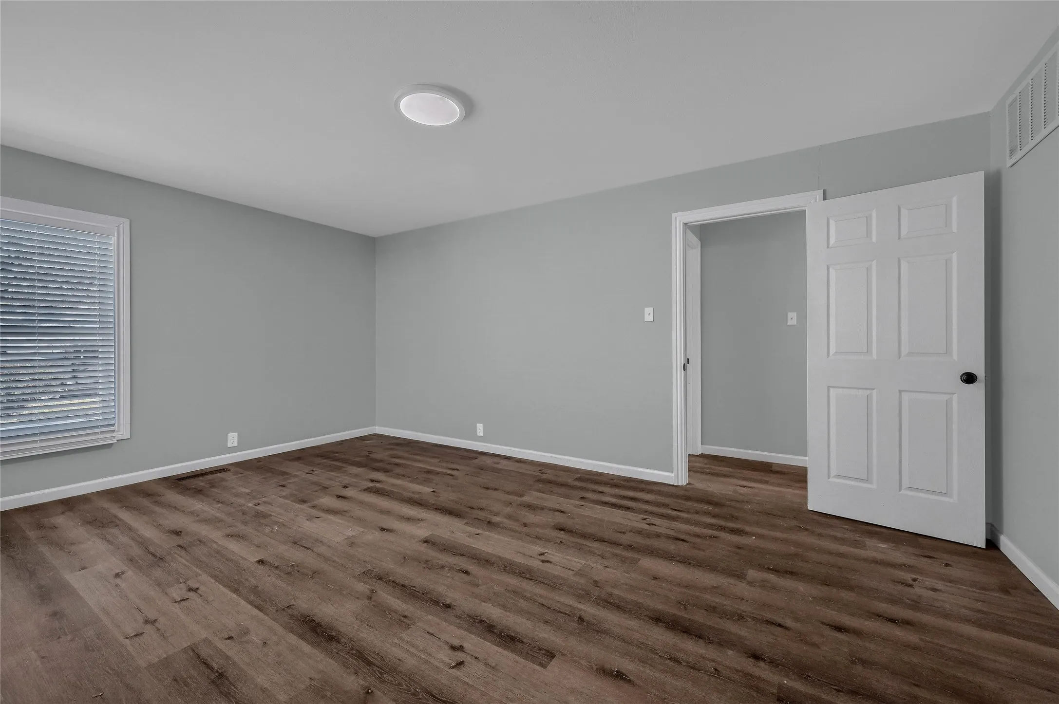 Empty room with dark wood-type flooring