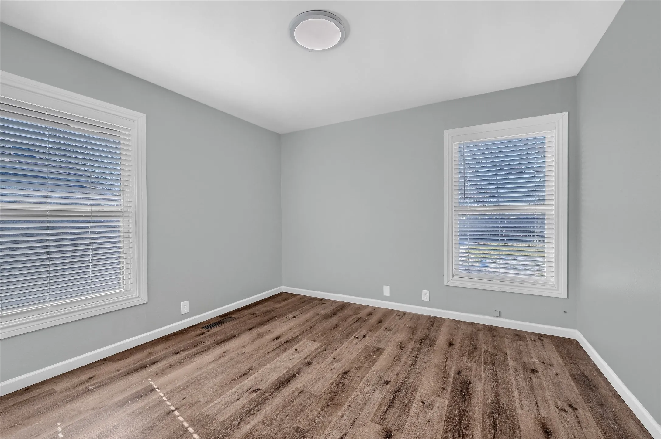 Empty room with light hardwood / wood-style flooring