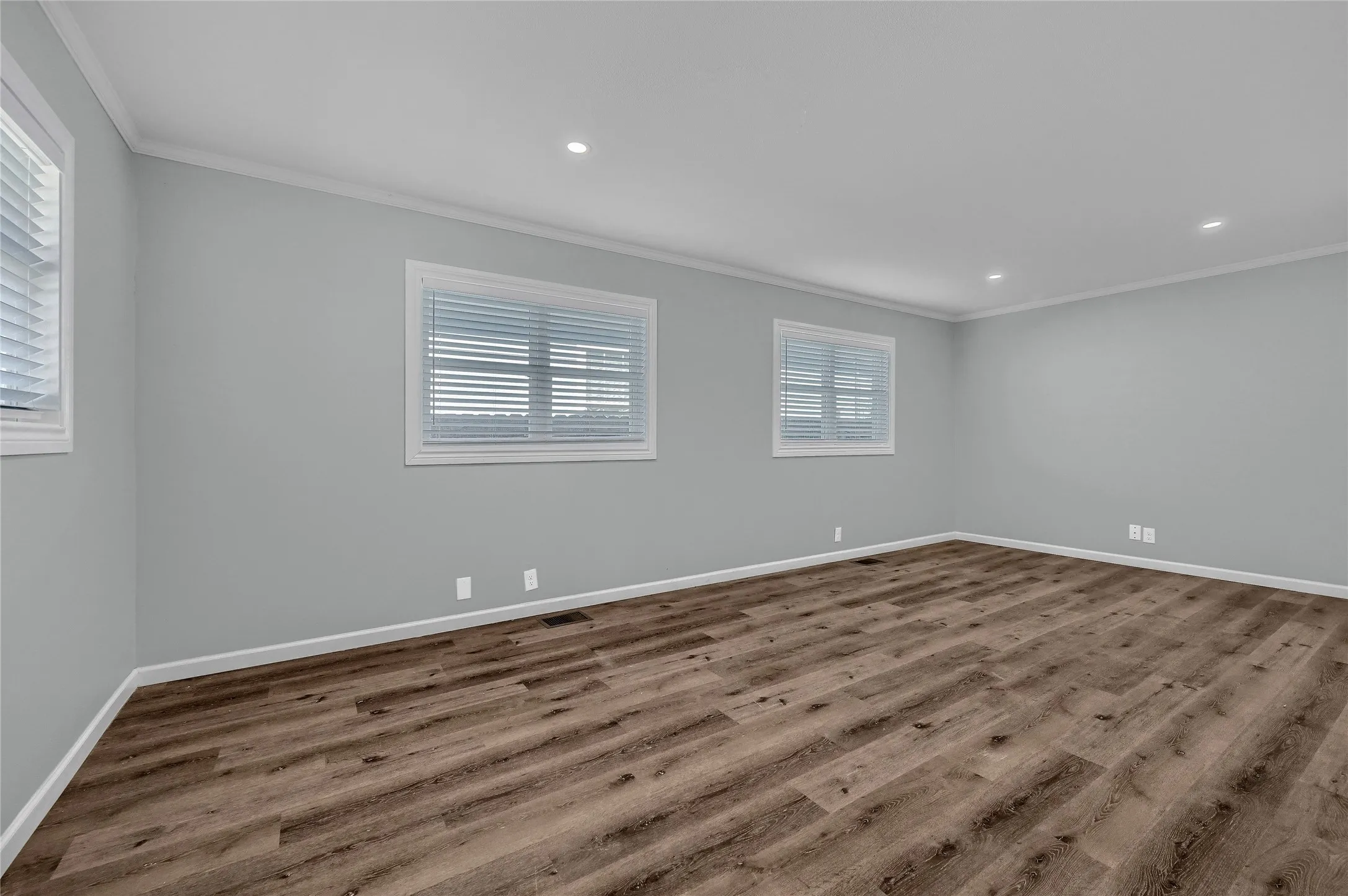 Spare room featuring crown molding and hardwood / wood-style flooring