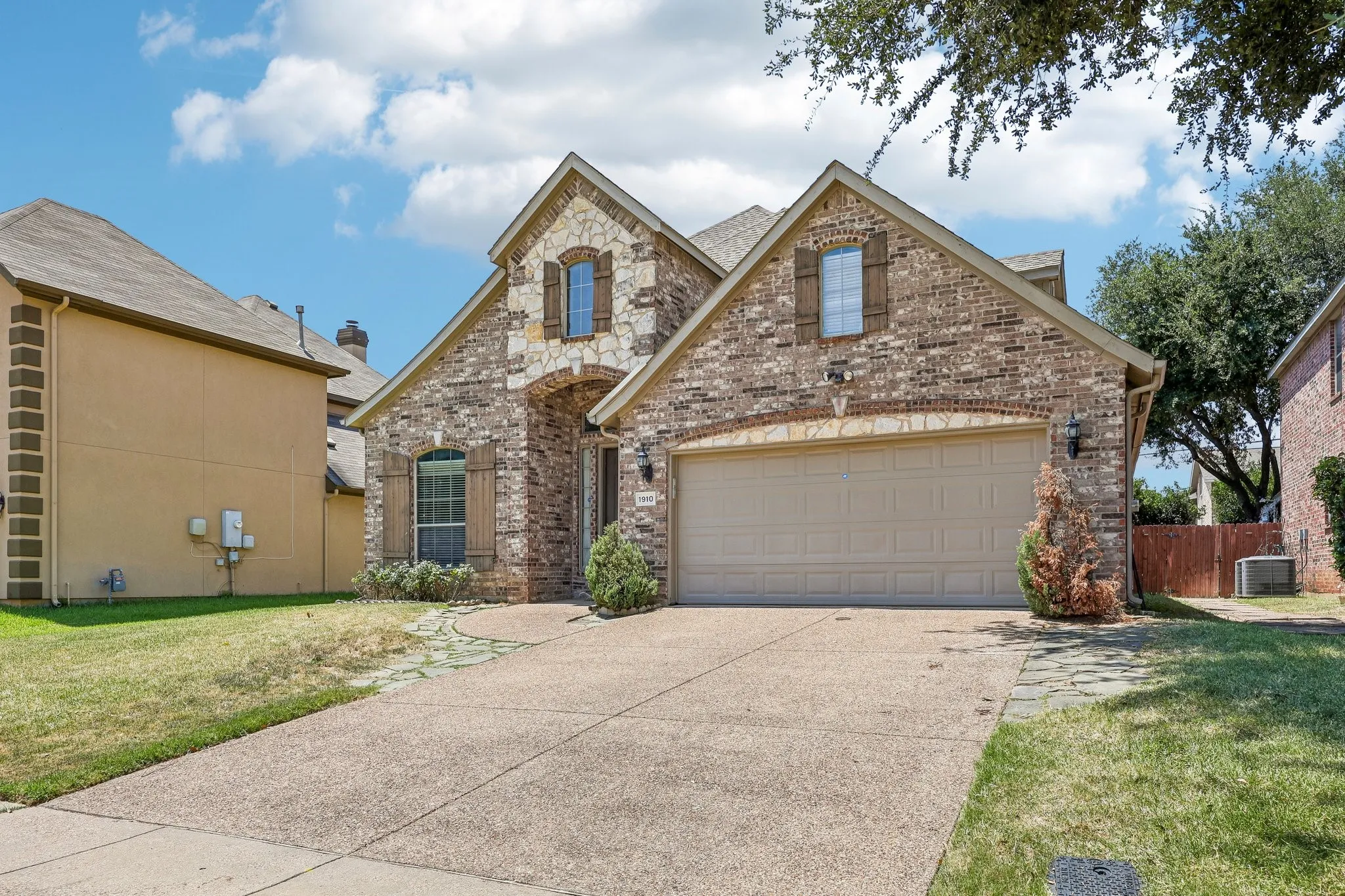 Traditional-style home featuring a brick and stone facade