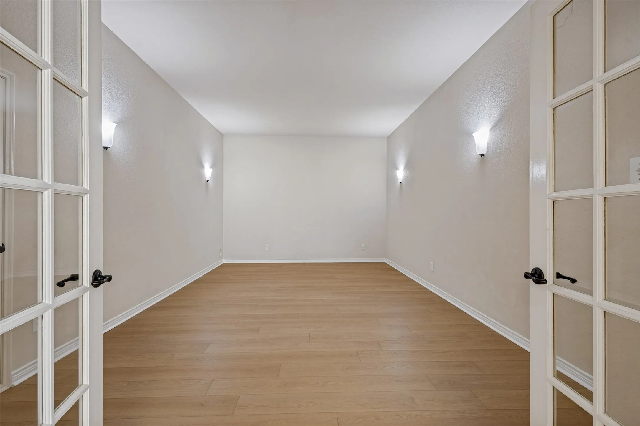 Wood-finish flooring with neutral wall paint and white trim