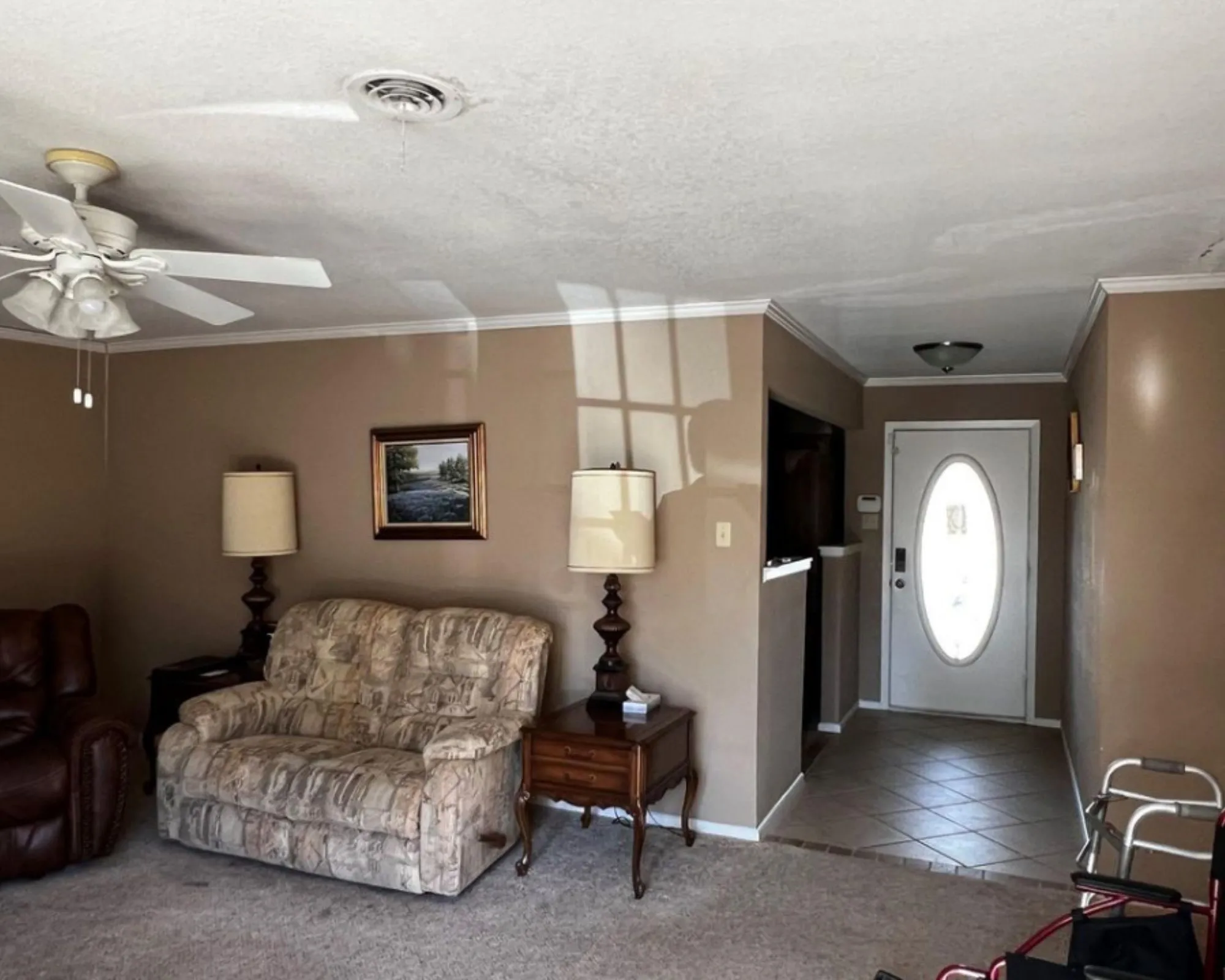 Entryway featuring a white oval-lite door and tiled flooring