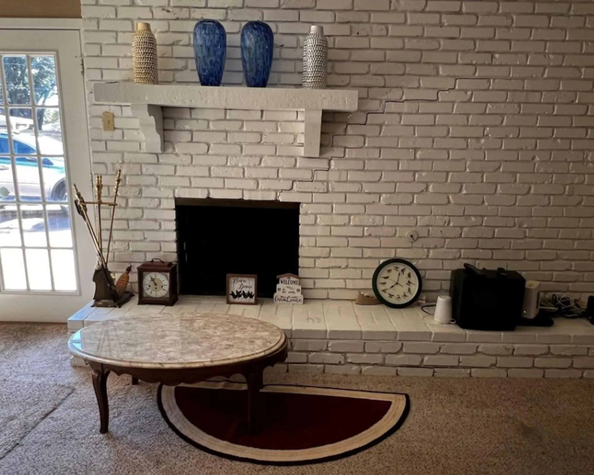 White-painted brick fireplace with a mantle shelf and a hearth