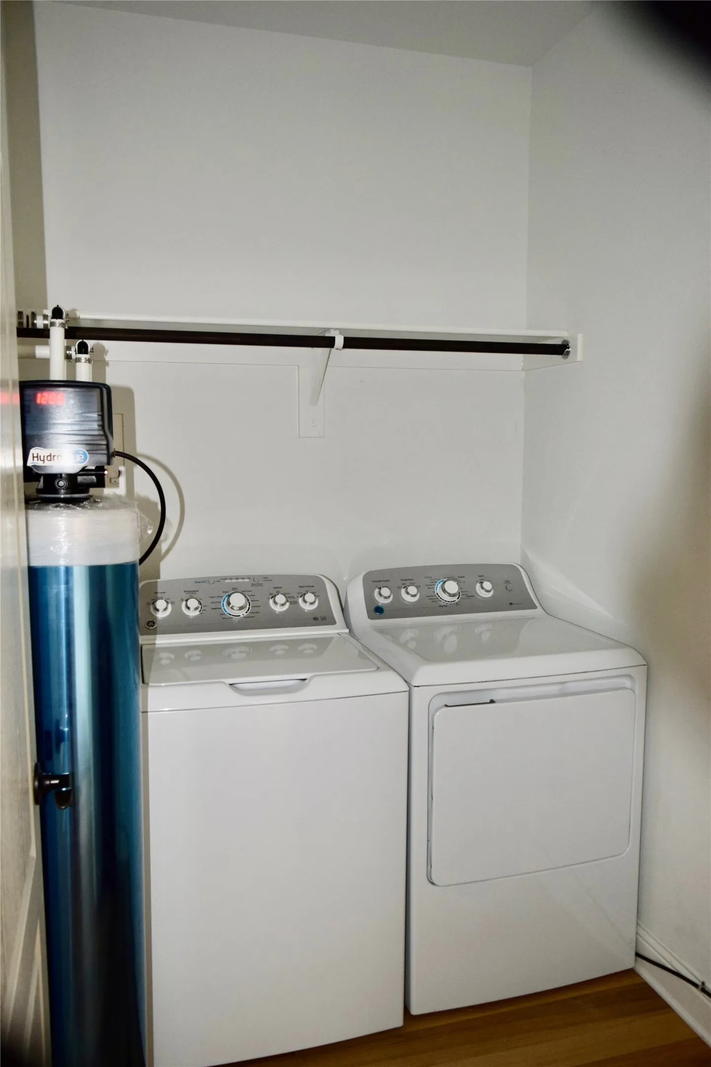 Laundry room with washer and dryer and wood-type flooring