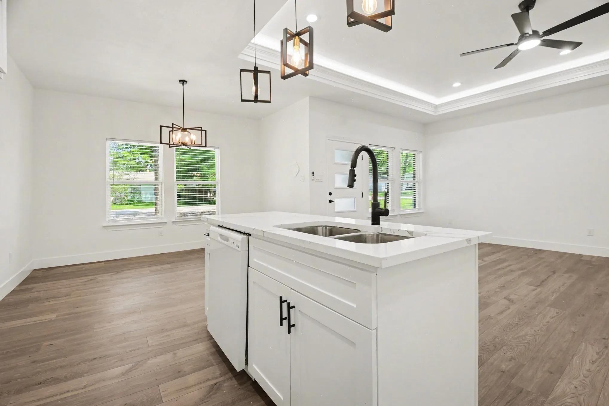 Kitchen island with dual basin sink, integrated dishwasher, and black hardware