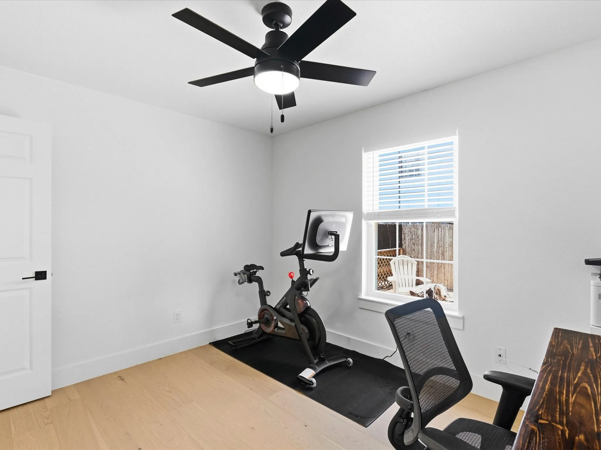 Recessed lighting, ceiling fan with integrated lighting, wood-finish flooring, white paneled door, and window with blinds