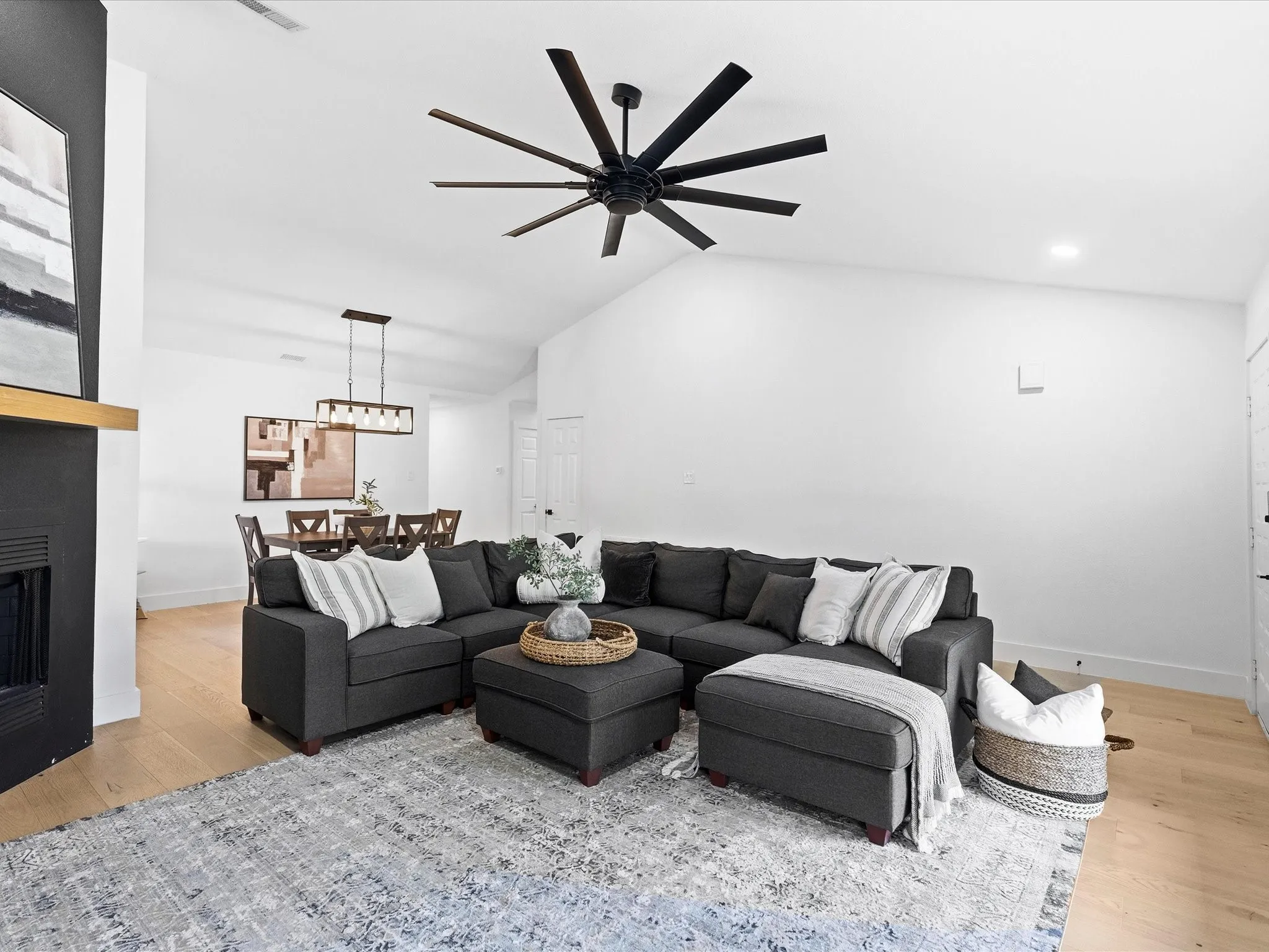 Vaulted ceiling in the living area with a large ceiling fan and recessed lighting
