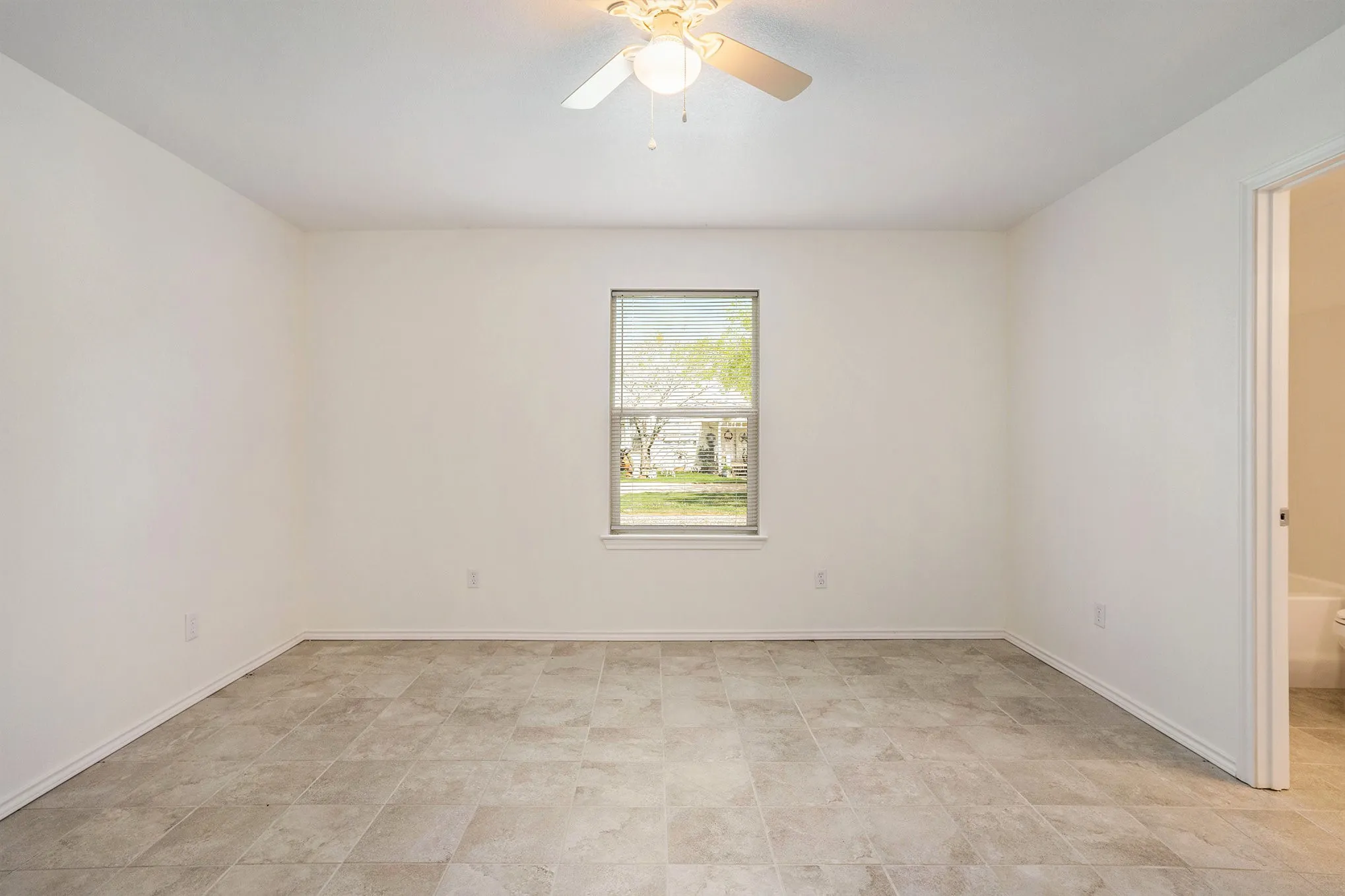 Recessed window with white trim, ceiling fan with integrated lighting, and tile flooring
