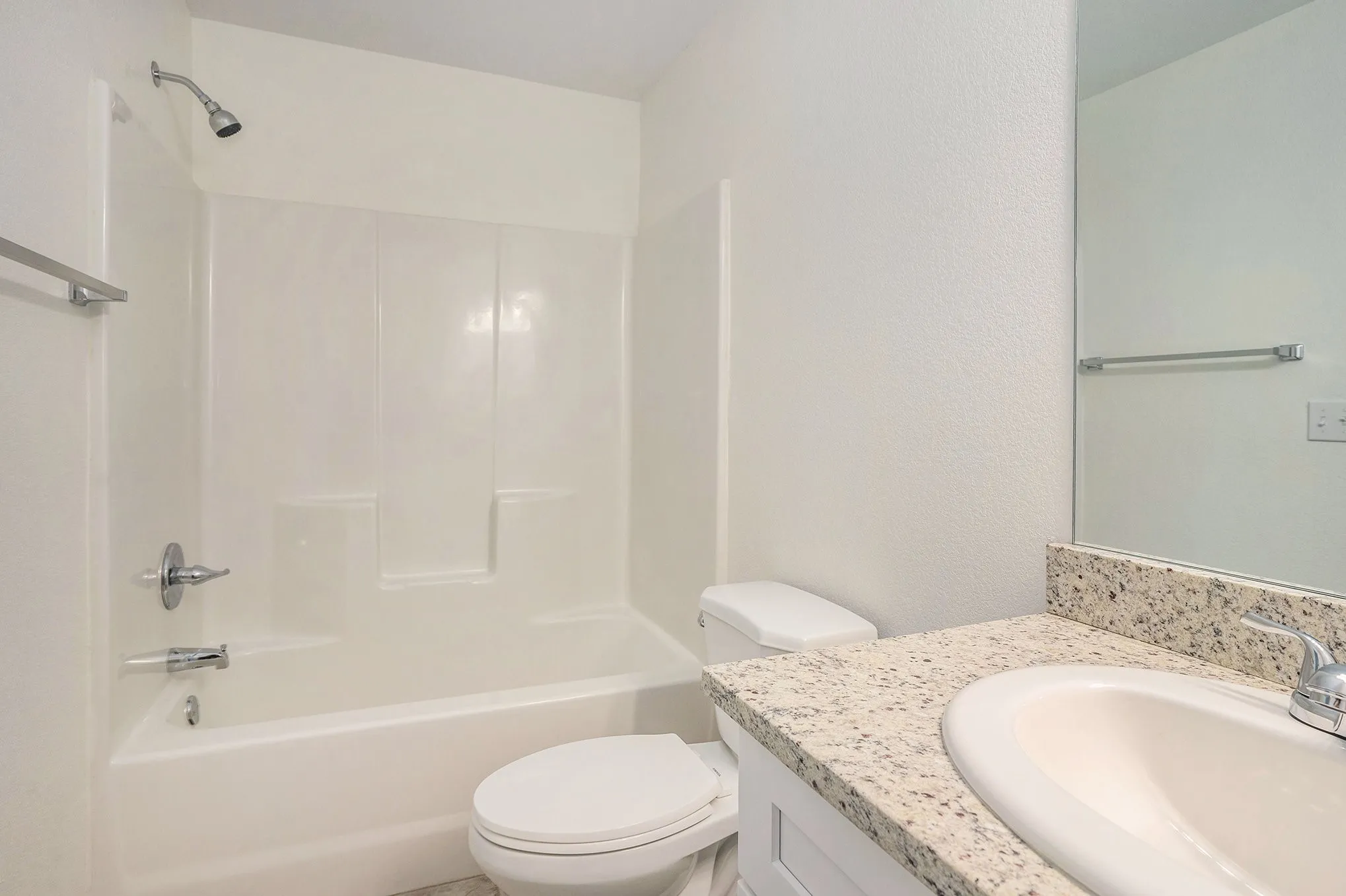 White shower-over-tub combination with chrome fixtures