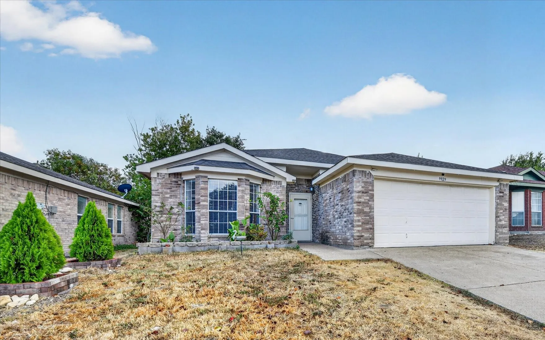 Exterior front view of the single-family home featuring classic architecture, beautifully maintained landscaping, clean entryway, and vibrant curb appeal.