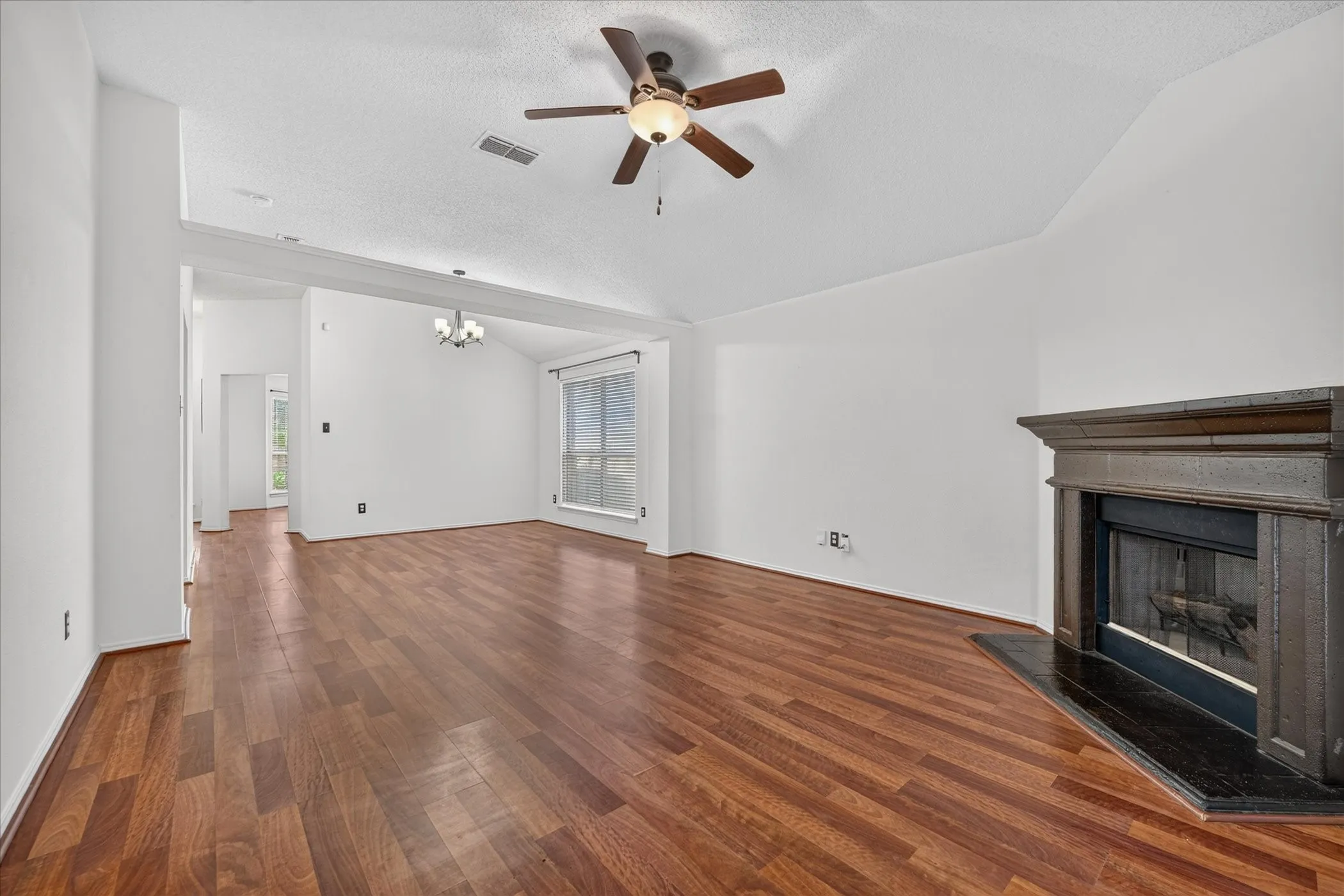 Alternate perspective of the open living area highlighting seamless flow into adjacent dining and kitchen spaces, ideal for hosting and family gatherings.