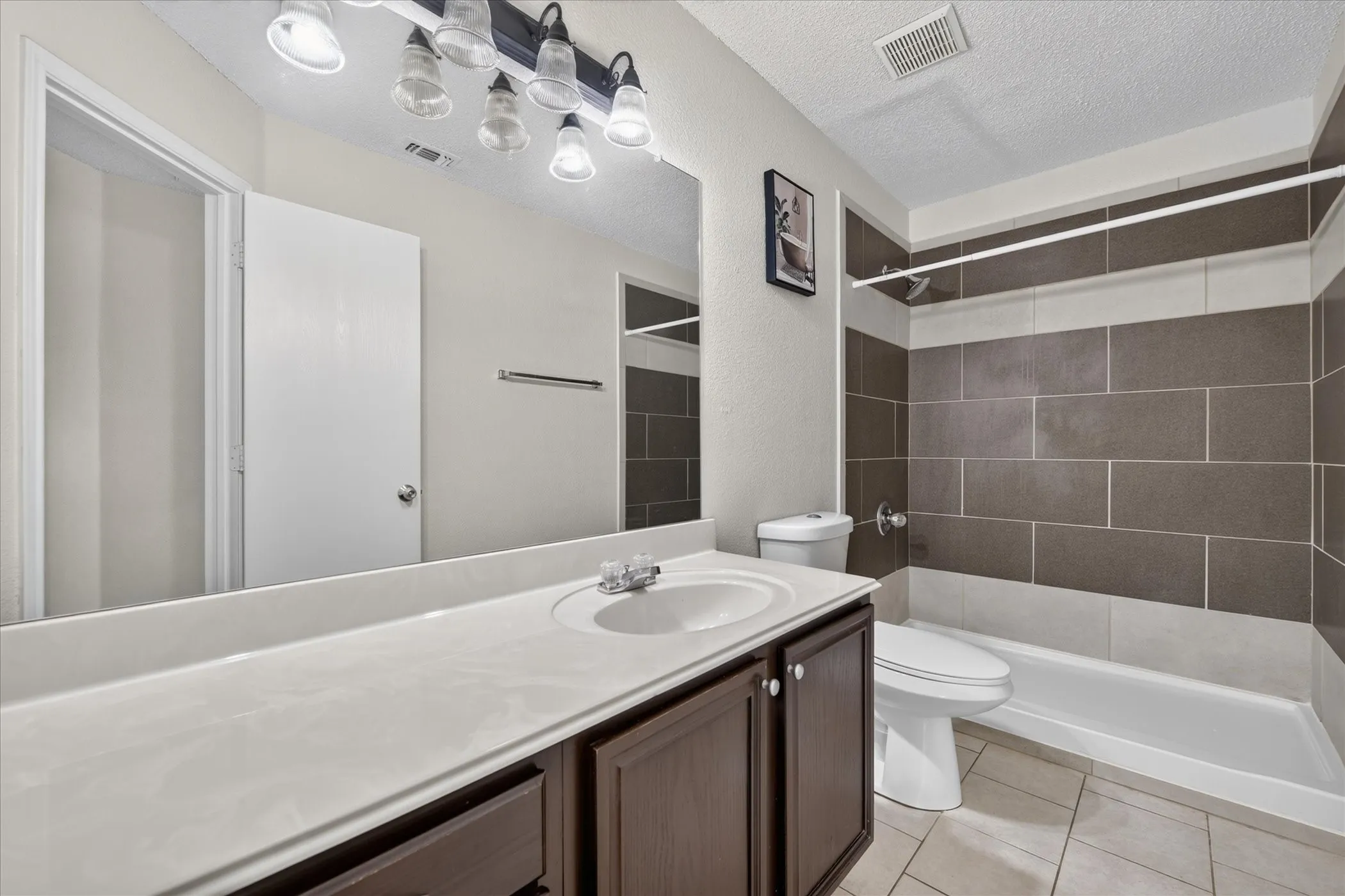 Additional bathroom showing neat fixtures, modern vanity lighting, clean surfaces, and functional layout for guests or family members.